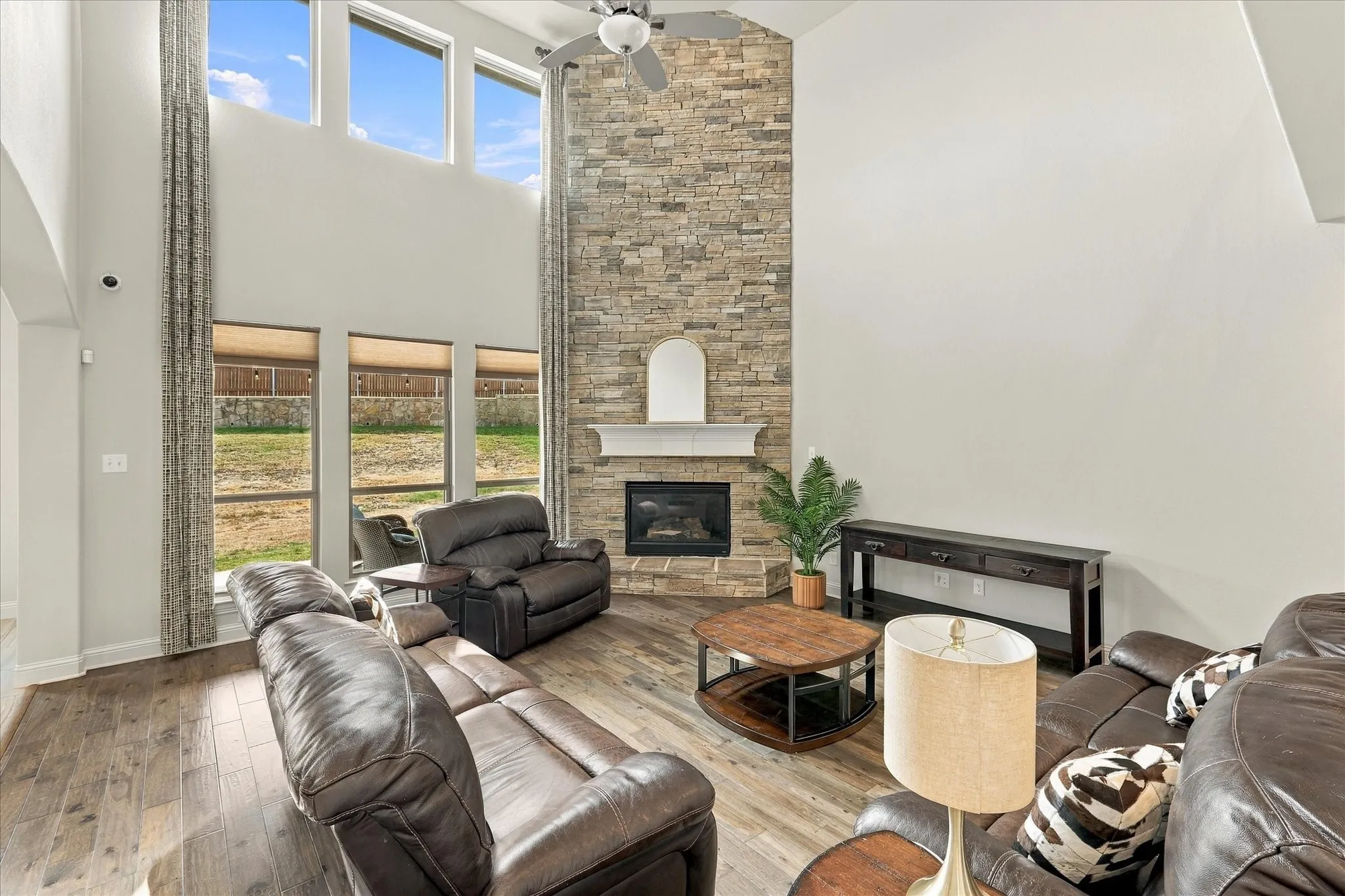 The grand fireplace highlights the tall ceiling in this living room