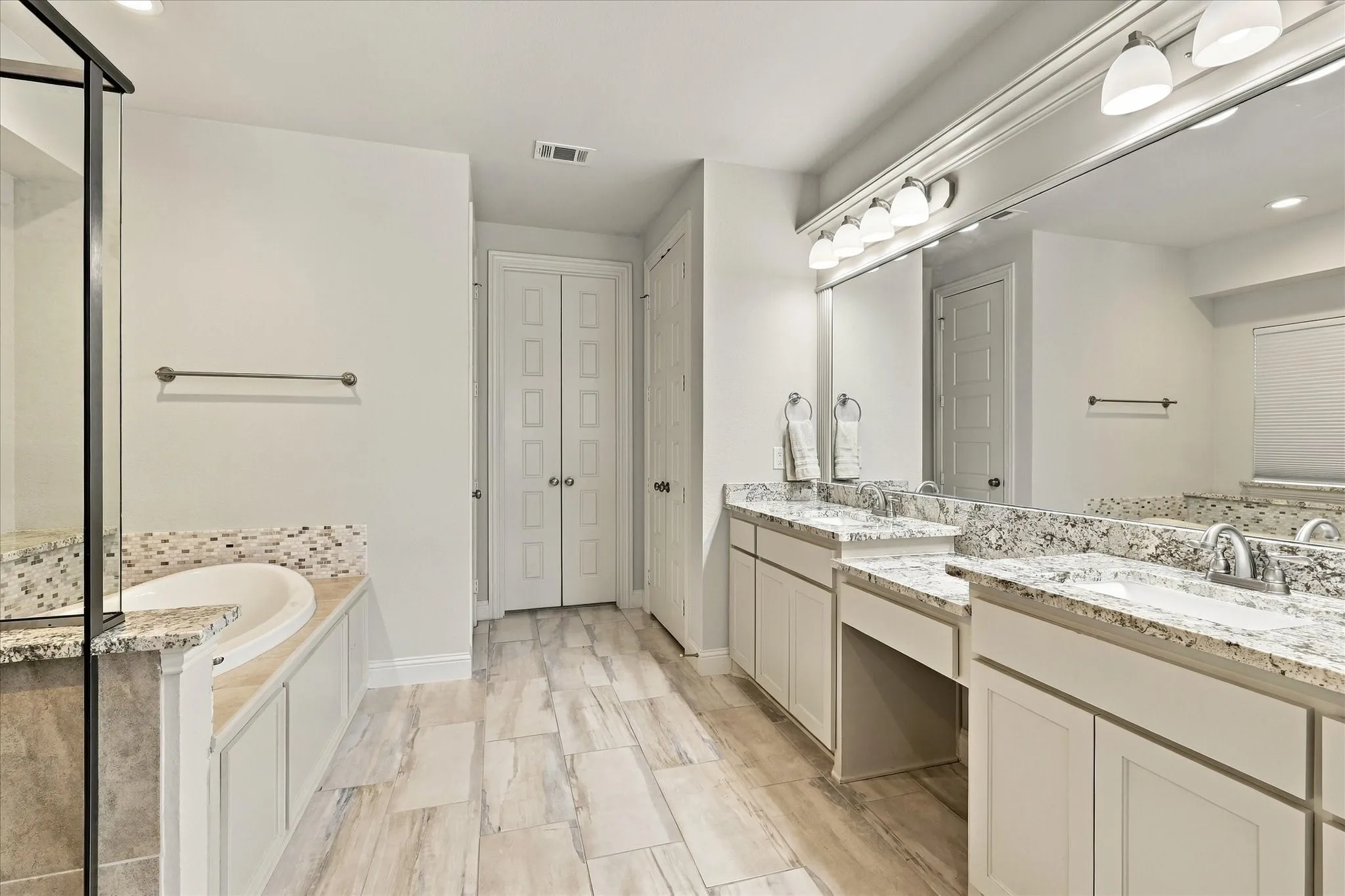 The primary bath has dual sinks and vanity counter