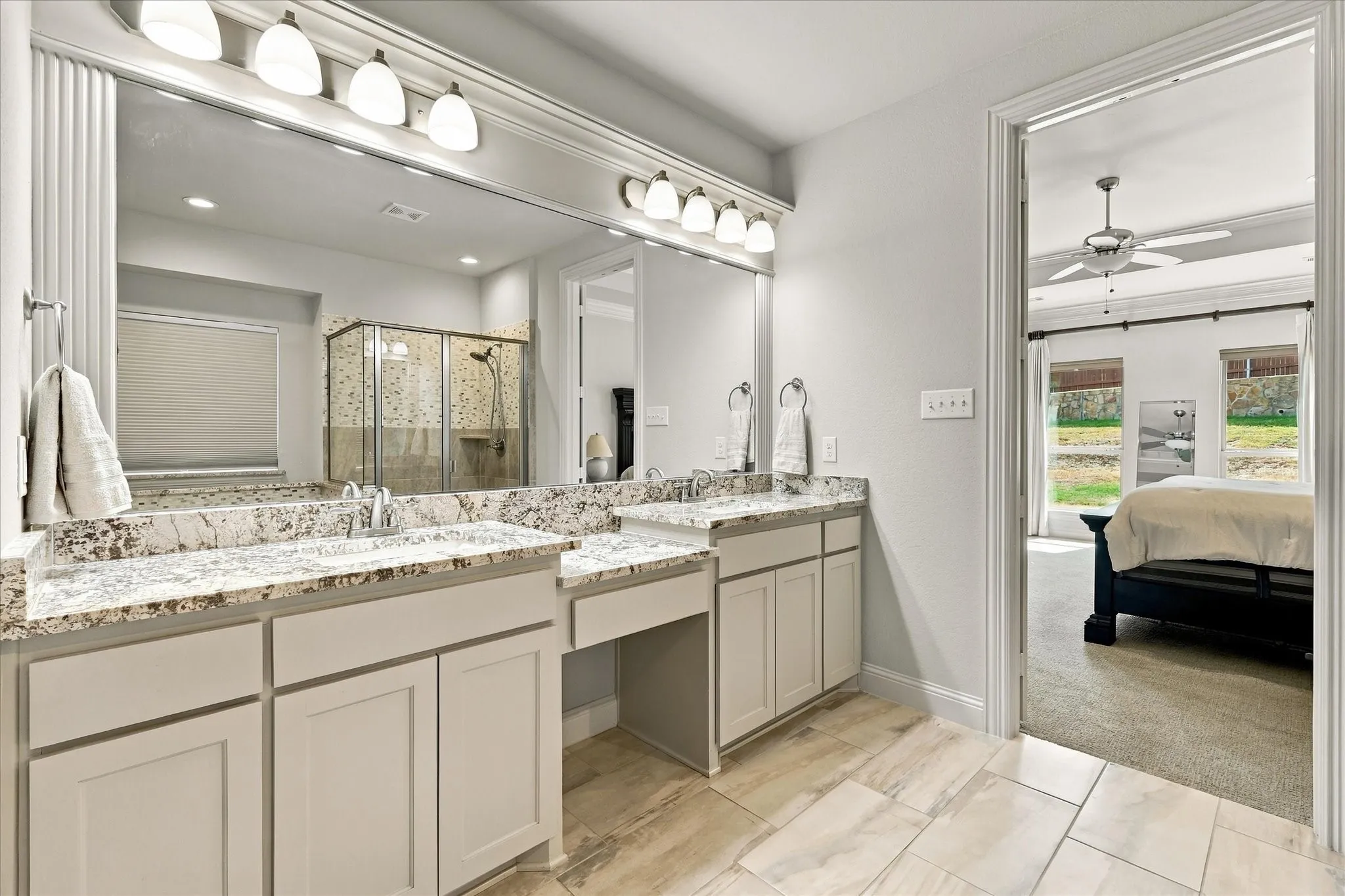 A view from the ensuite bathroom to the primary bedroom