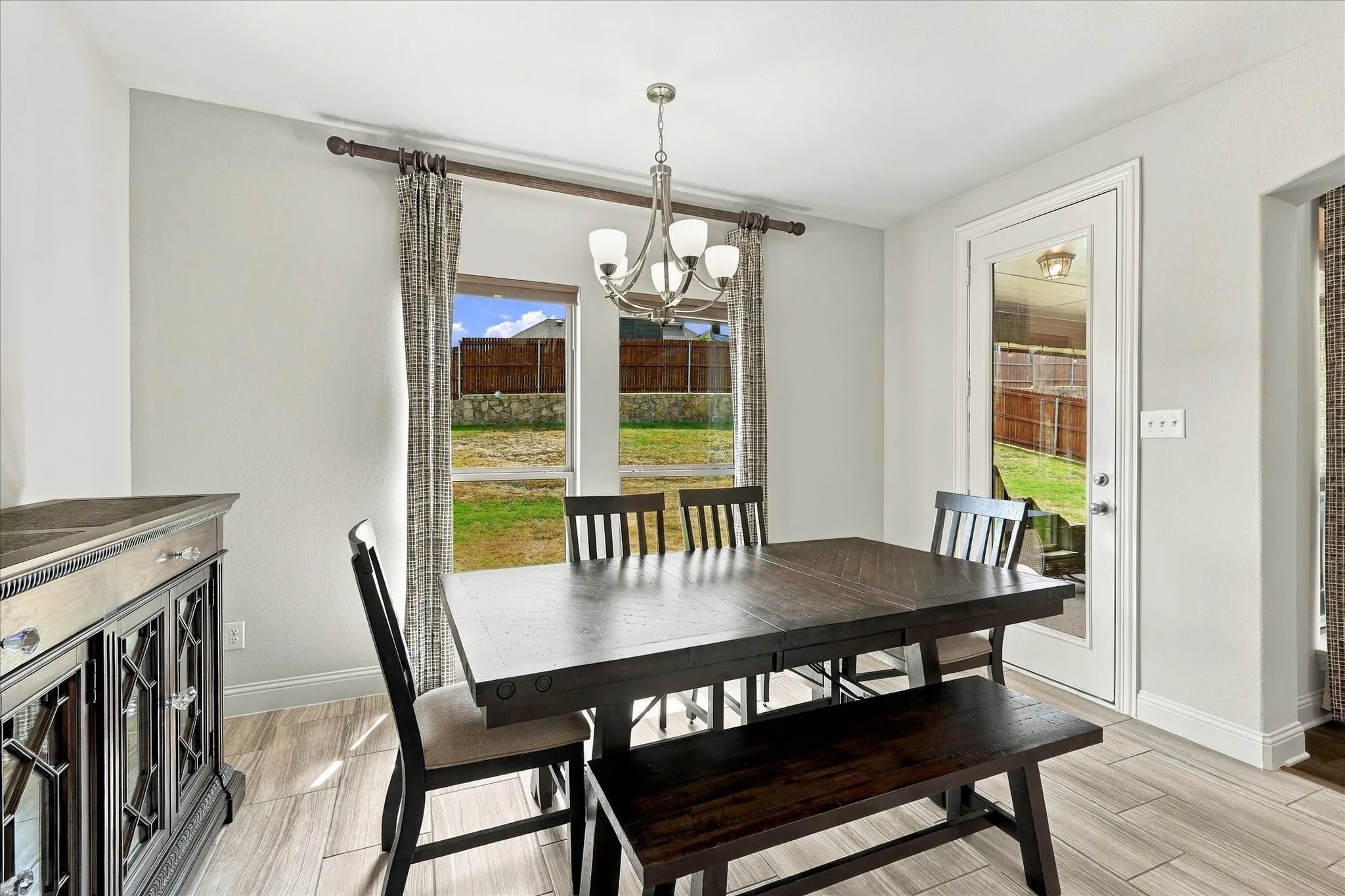 The dining area has natural light and views of the backyard
