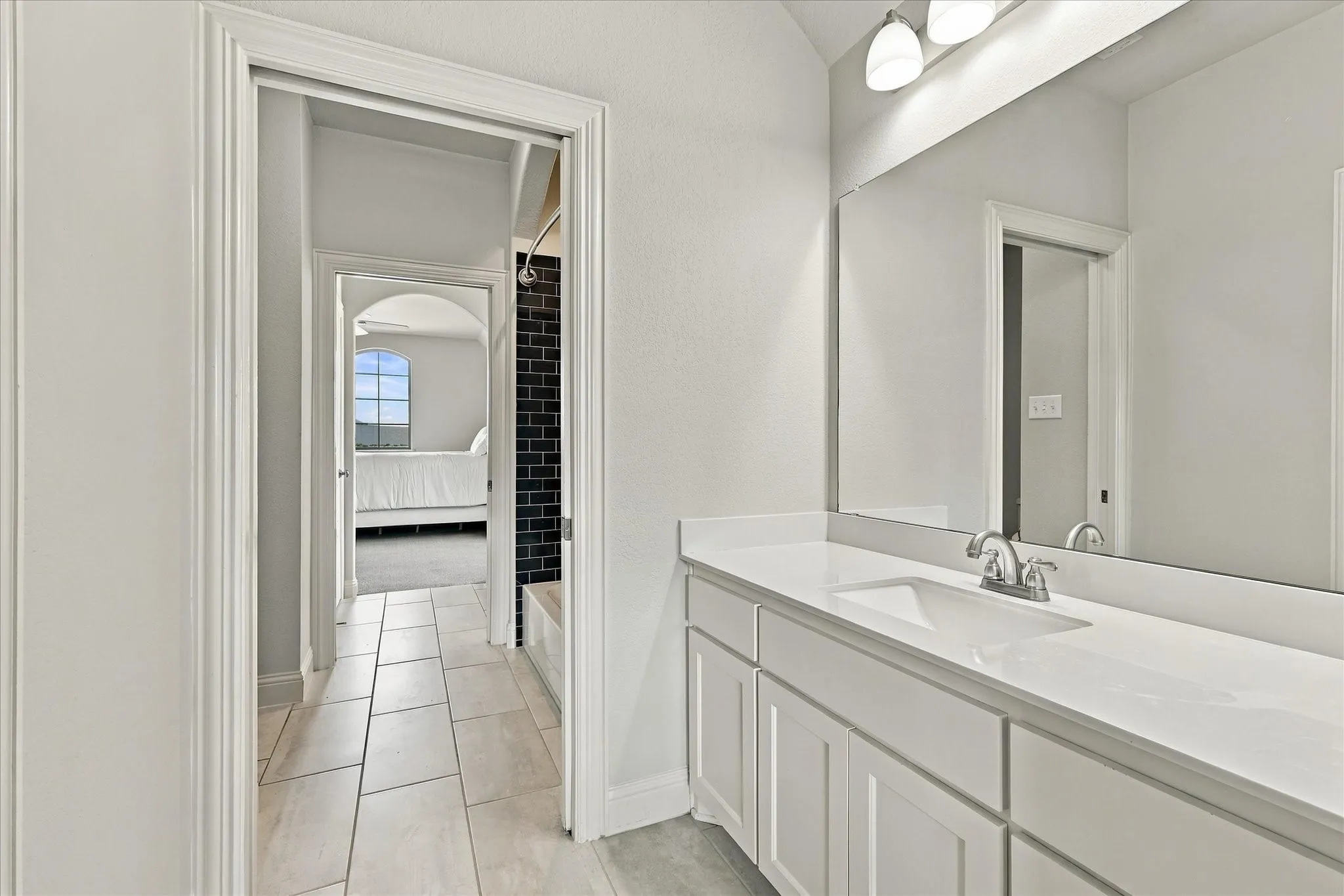 The jack-and-jill have separate vanities and privacy offered by pocket doors