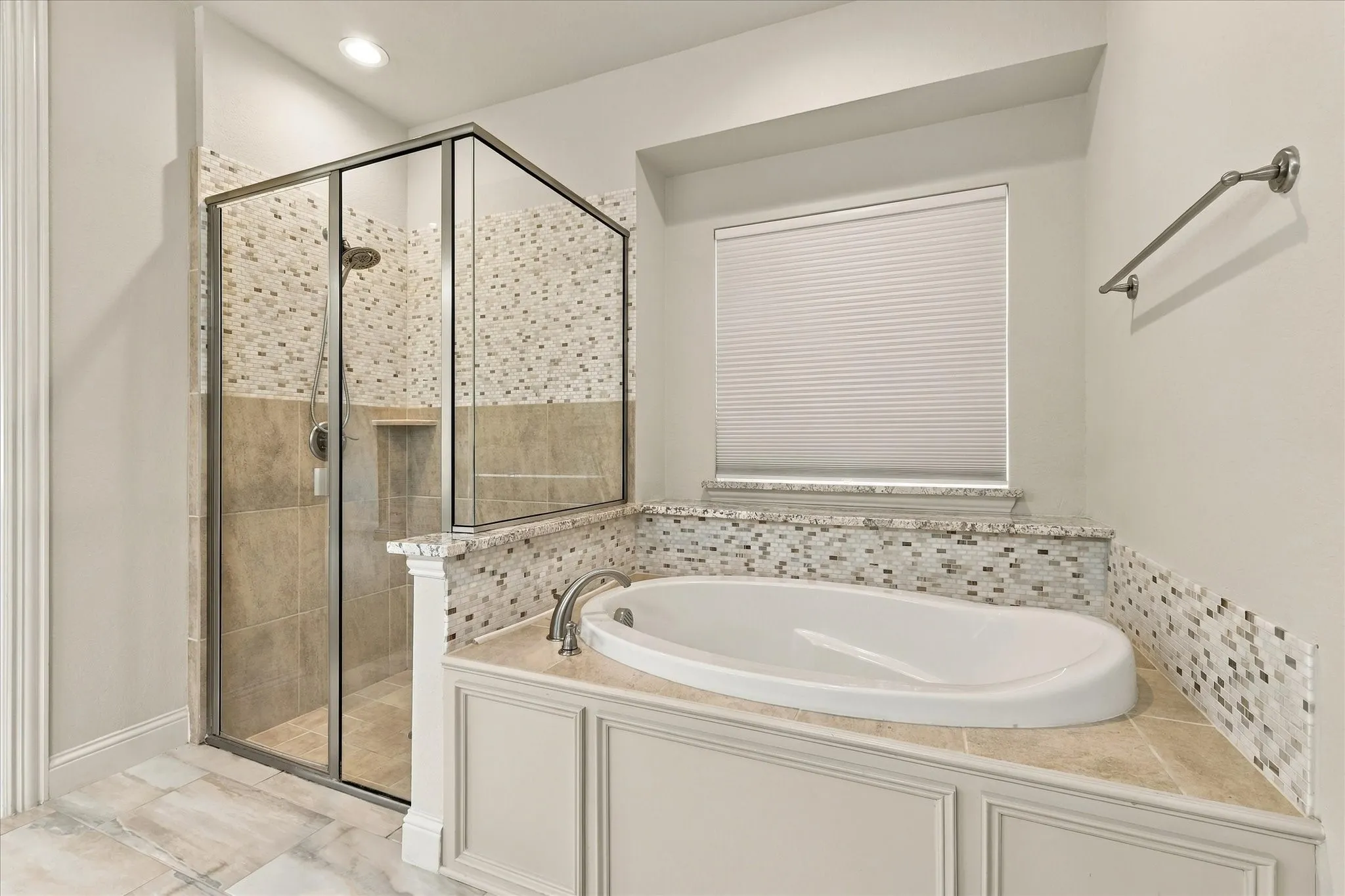 This comfy bathroom has a separate shower and soaking tub