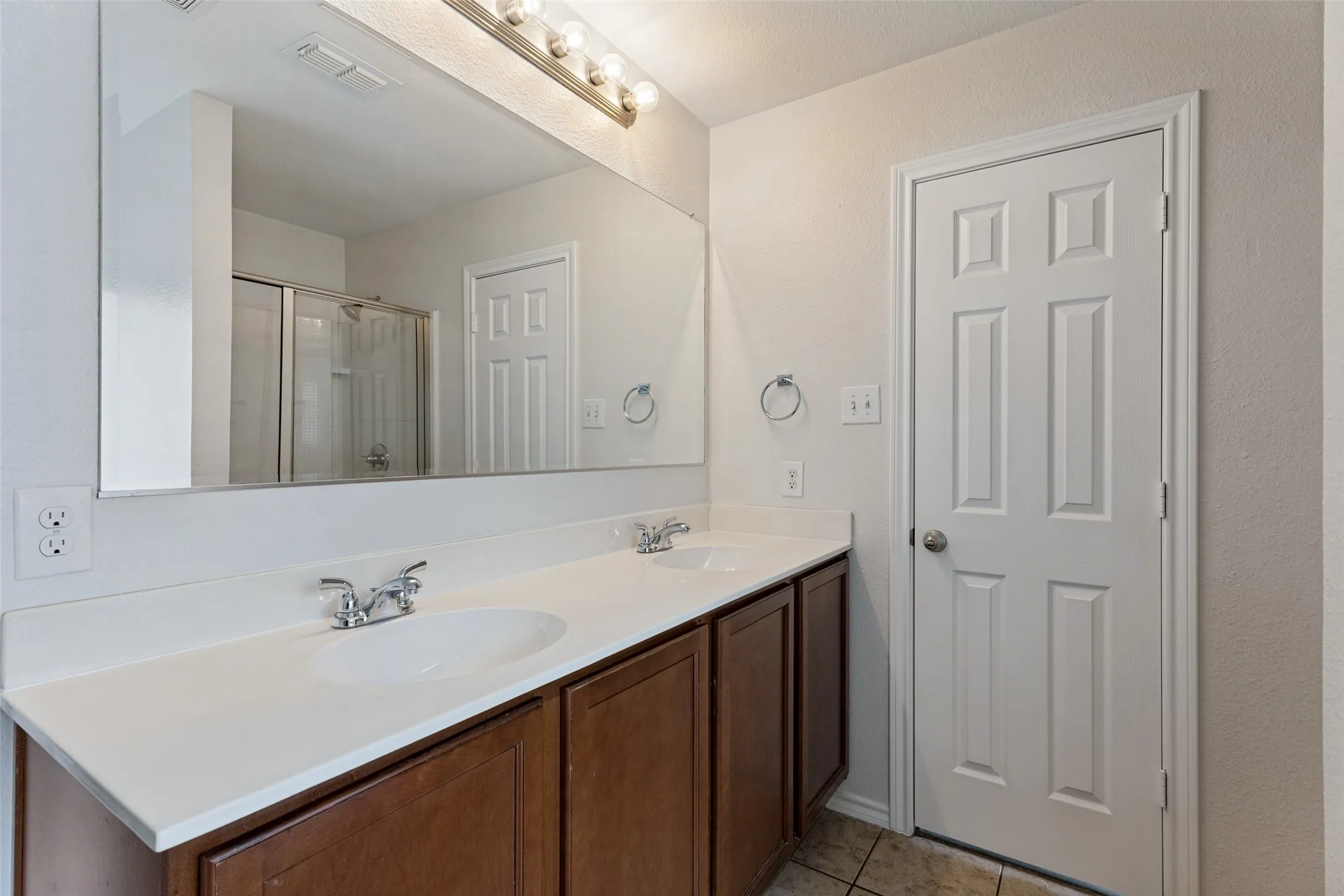 Dual vanity with white countertop and integrated sinks