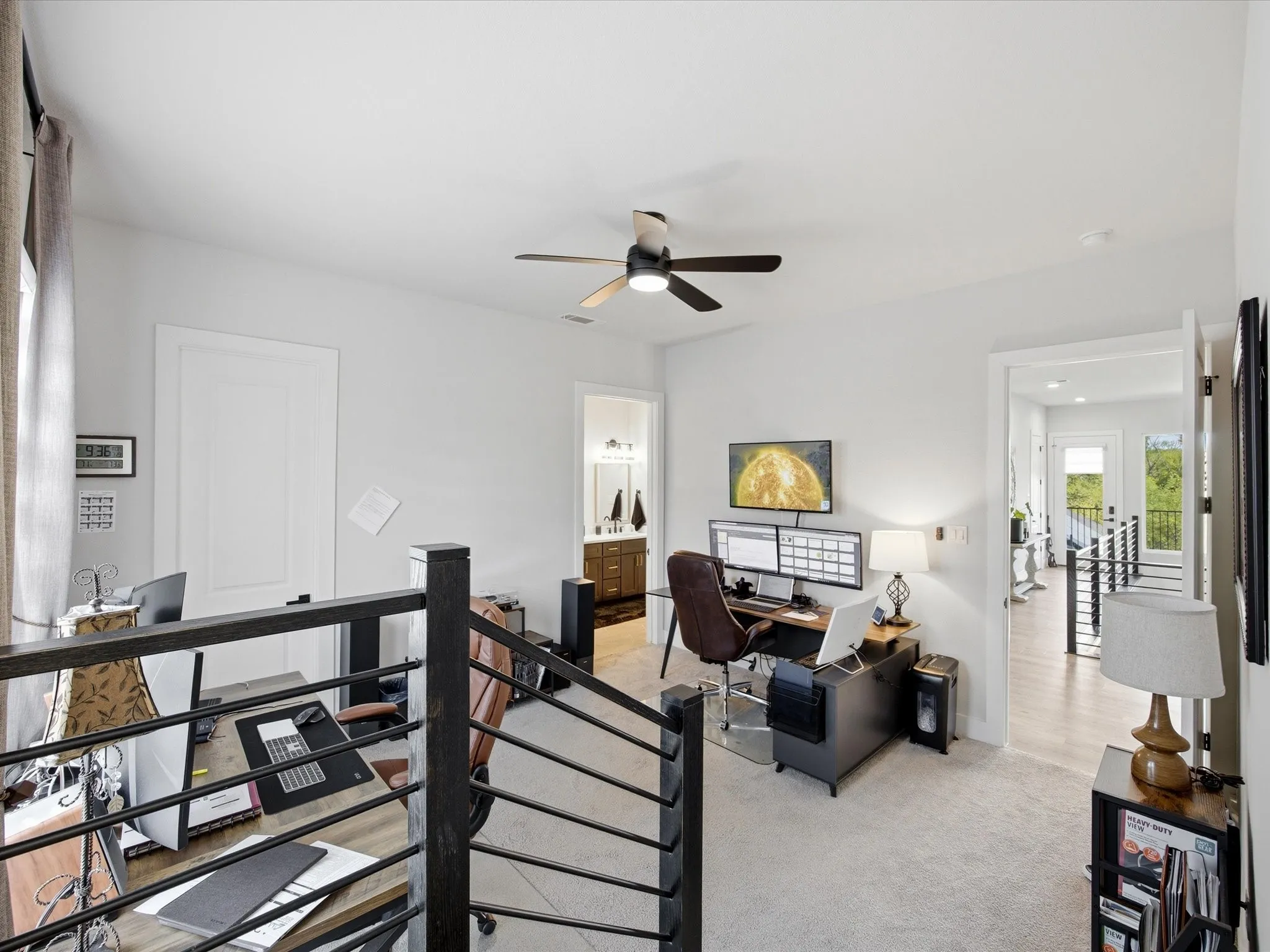 Office space featuring a ceiling fan and light colored carpet