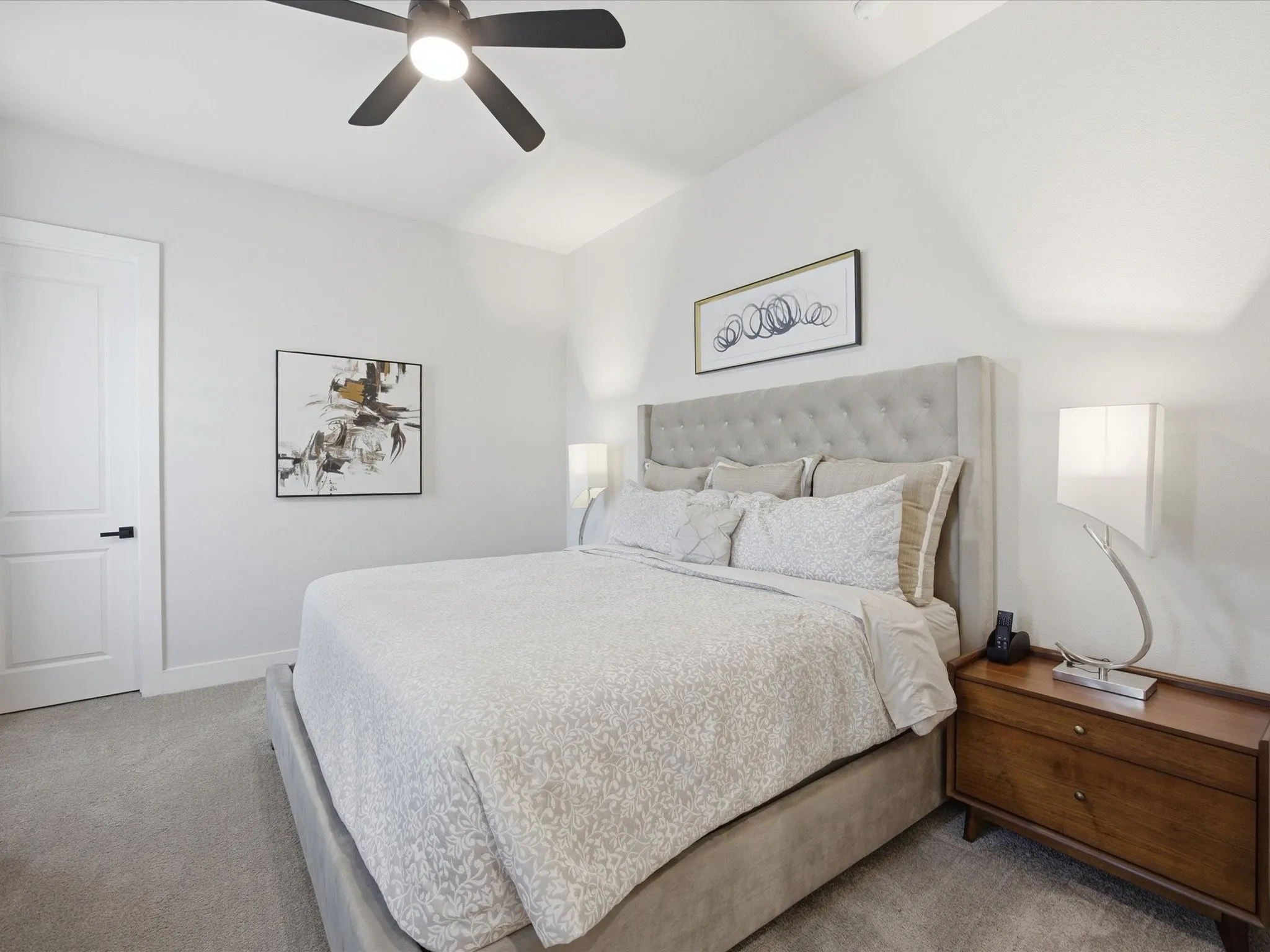 Bedroom with light colored carpet and a ceiling fan