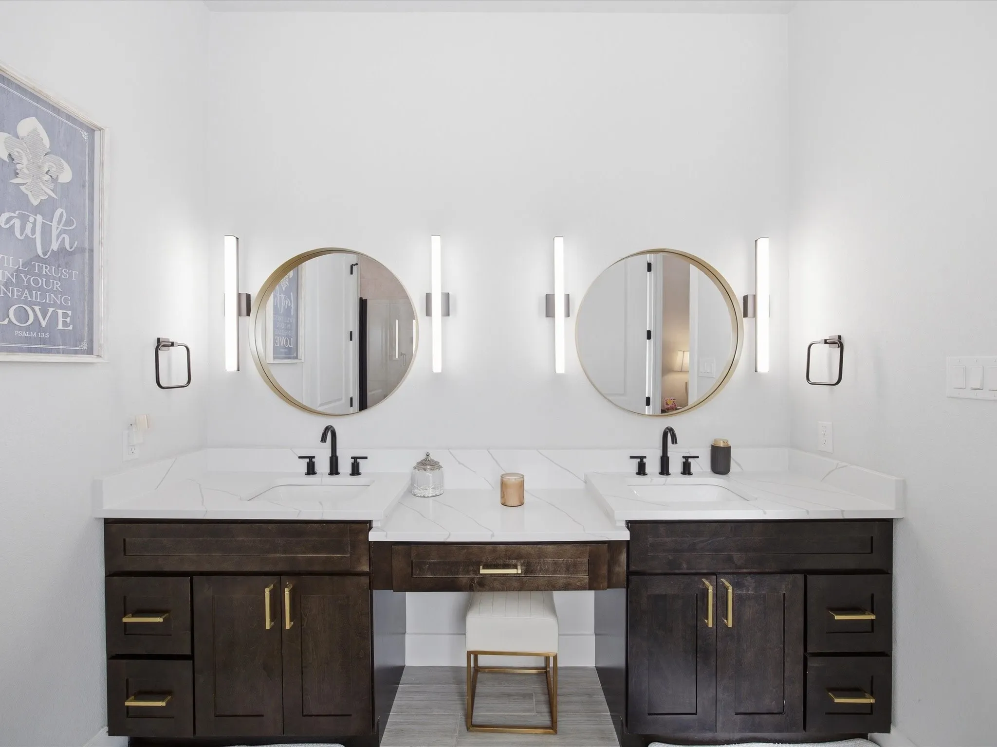 Full bathroom featuring double vanity and baseboards