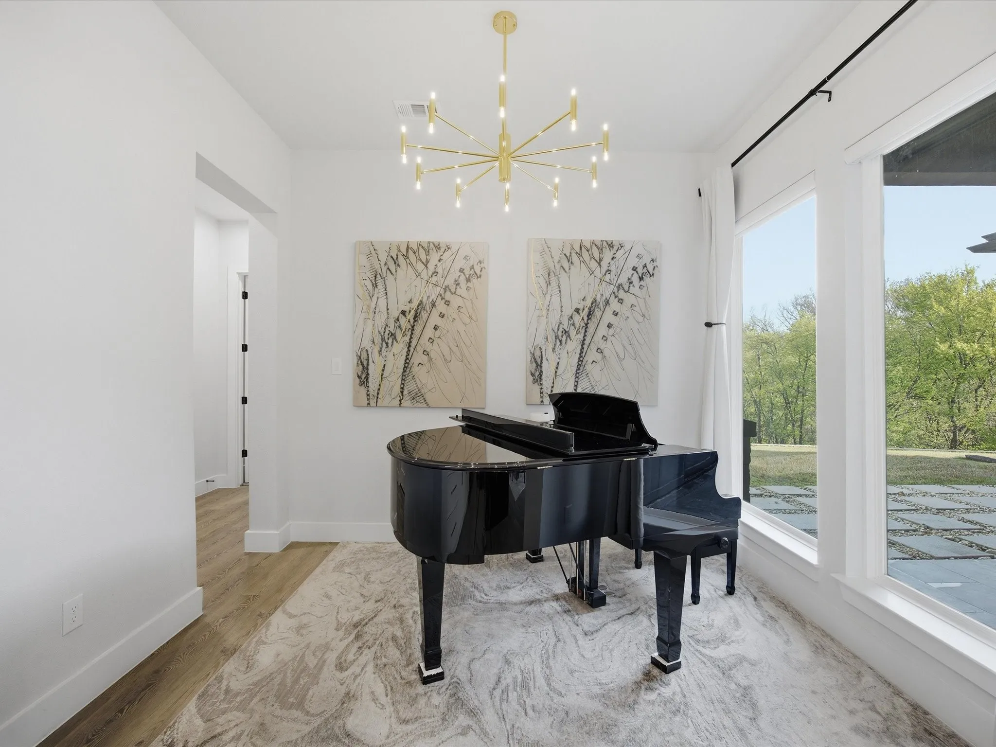 Sitting room with hanging lights and light wood finished floors