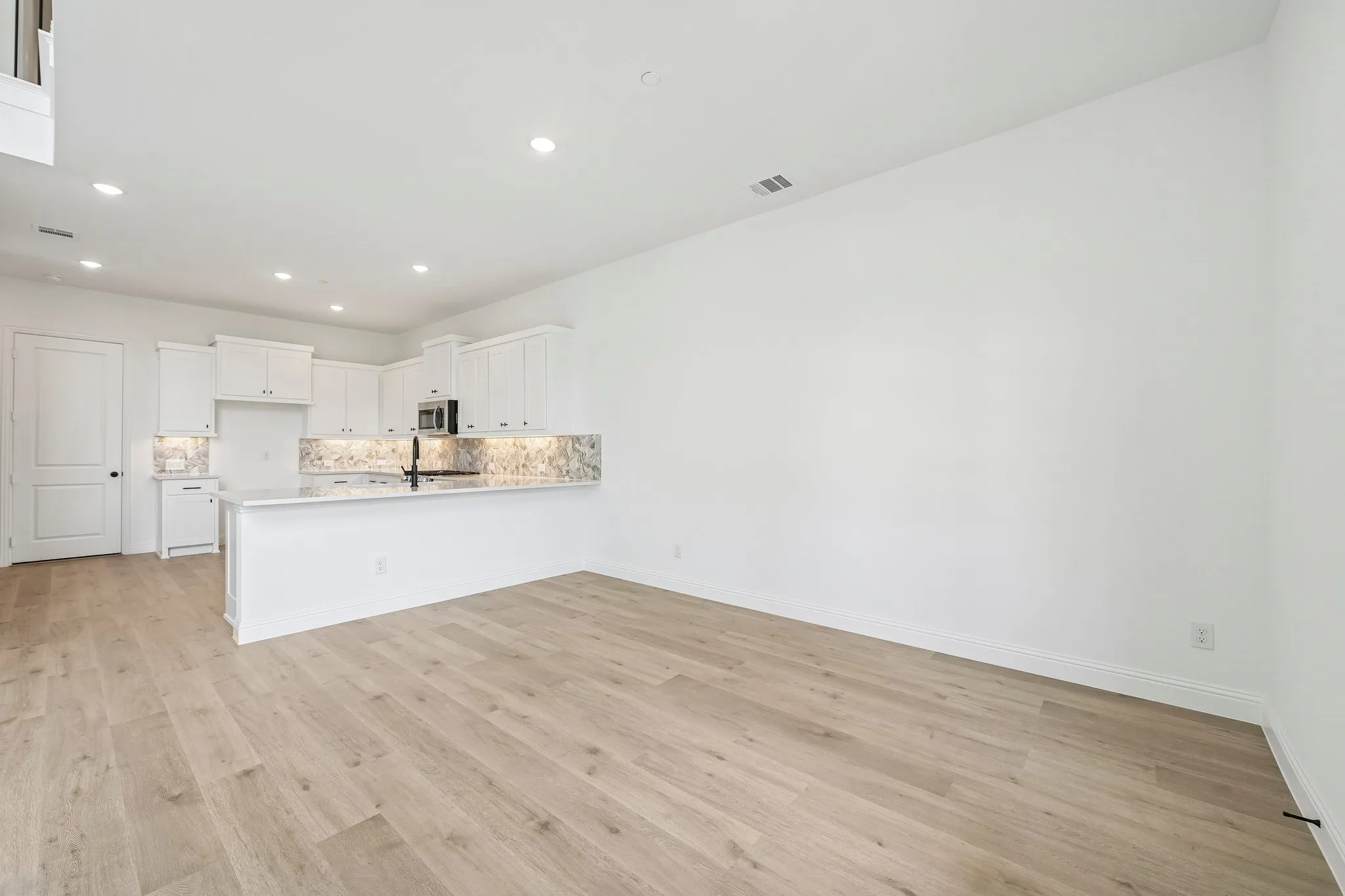 The kitchen features a spacious peninsula creating additional counter space and a breakfast bar.