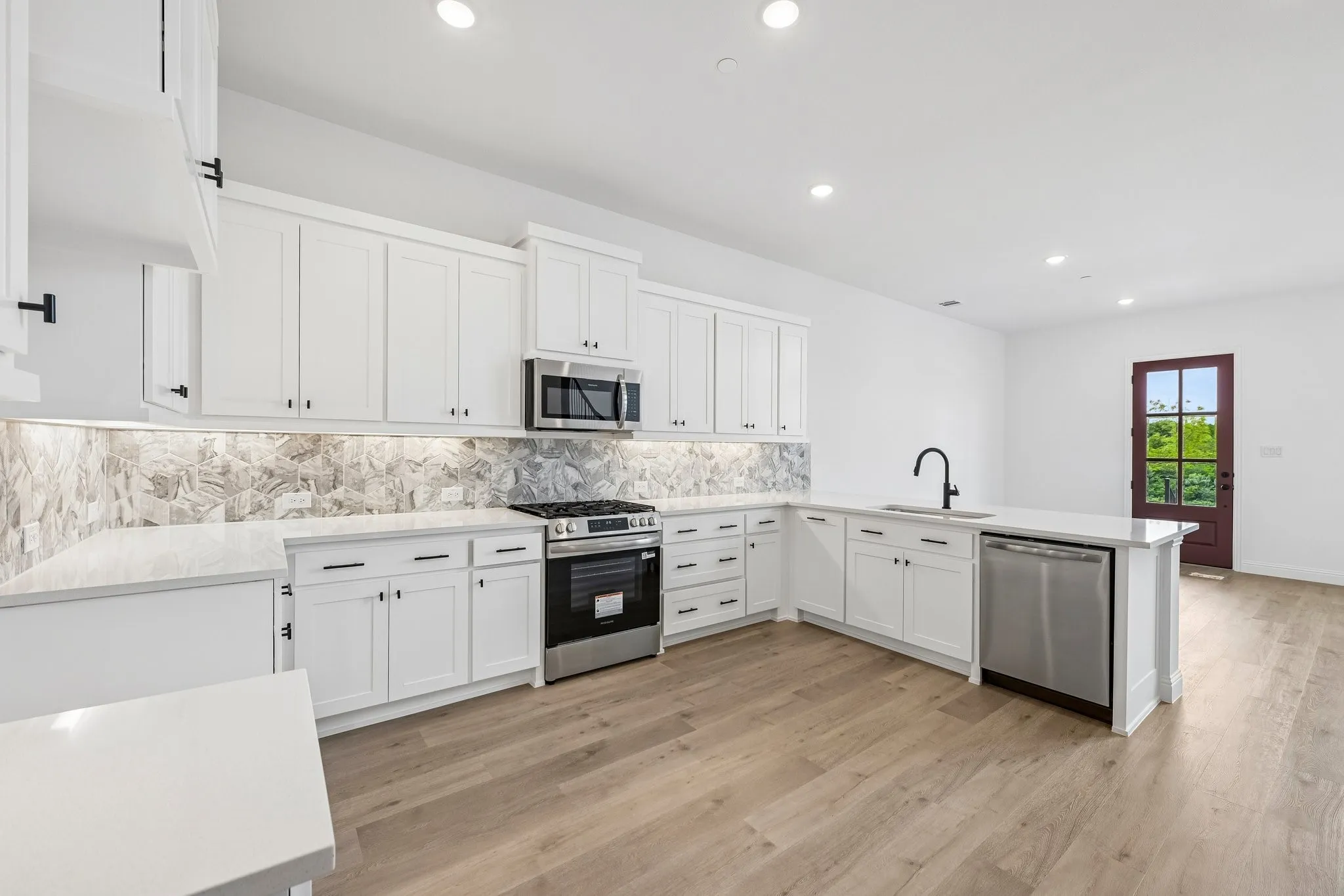 Beautiful cabinetry and gorgeous countertops are paired with stainless appliances to create a dream kitchen any chef would be proud to call their own!