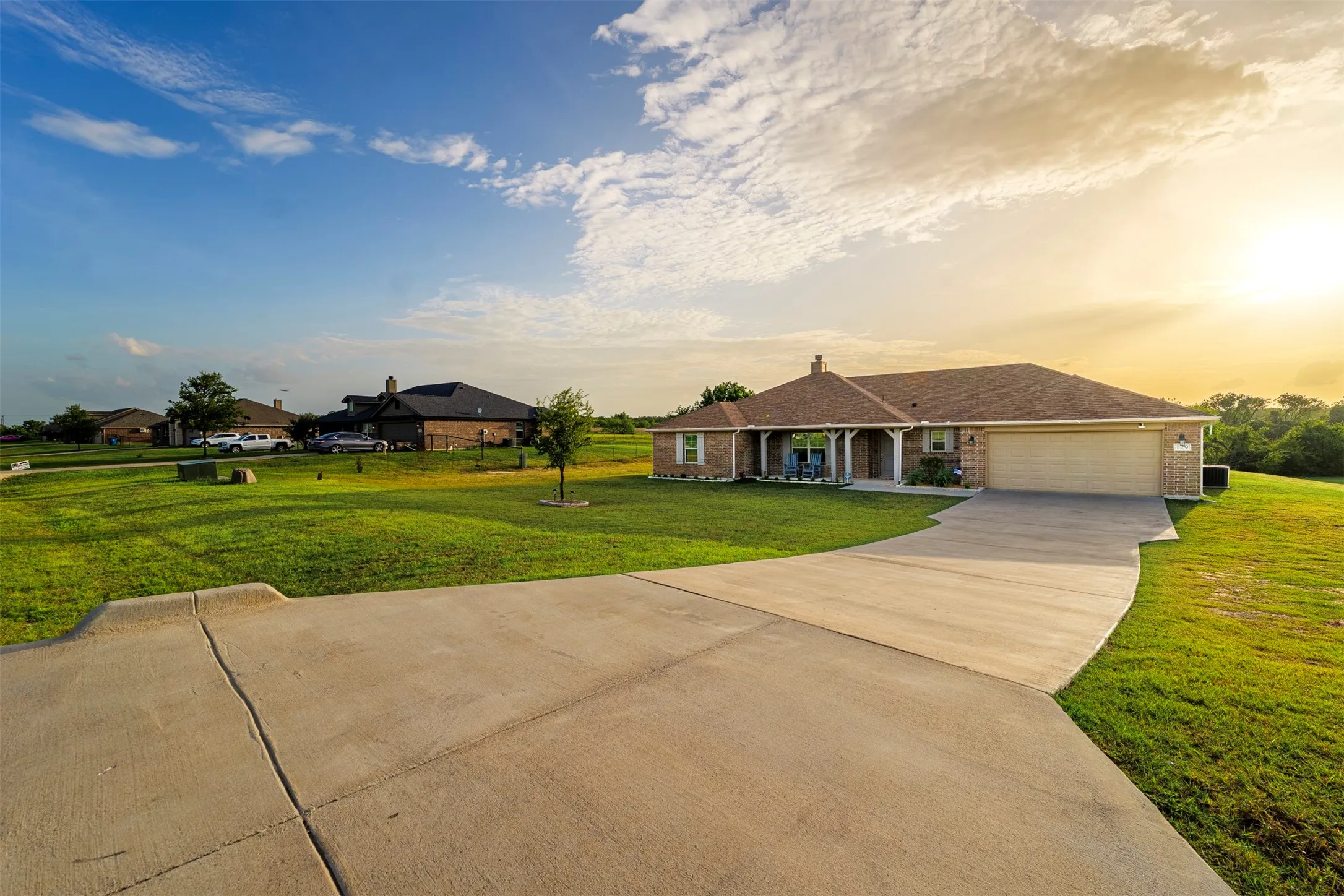 Brick exterior with a covered front porch and white columns