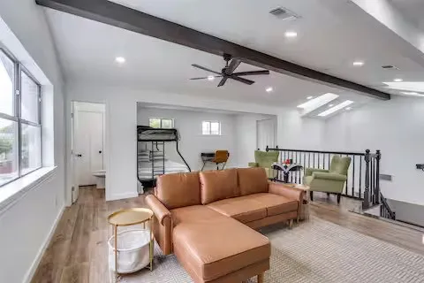 Exposed ceiling beams, recessed lighting, wood-finish flooring, multiple windows, and skylights
