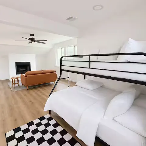 Open-concept room featuring wood-finish flooring, a contemporary fireplace, and recessed lighting