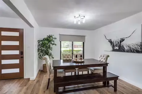 Wood-finish flooring throughout, with a recessed window and roller shade