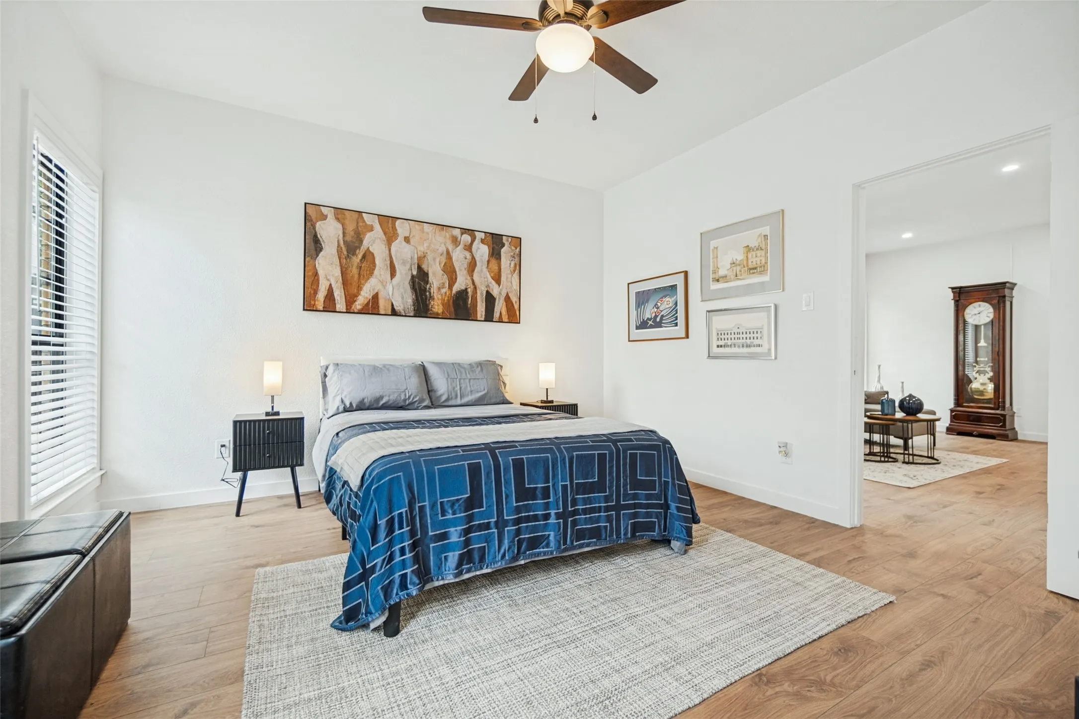 High ceilings, wood-finish flooring, ceiling fan with integrated lighting, recessed lighting, and a wide entryway
