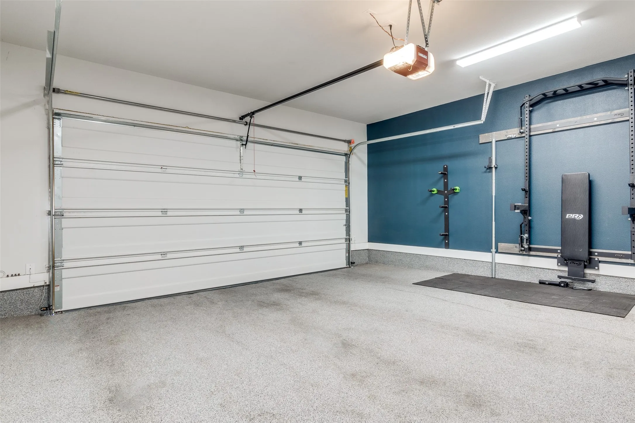 Large two car garage with collapsable workout equipment for tenant's enjoyment!