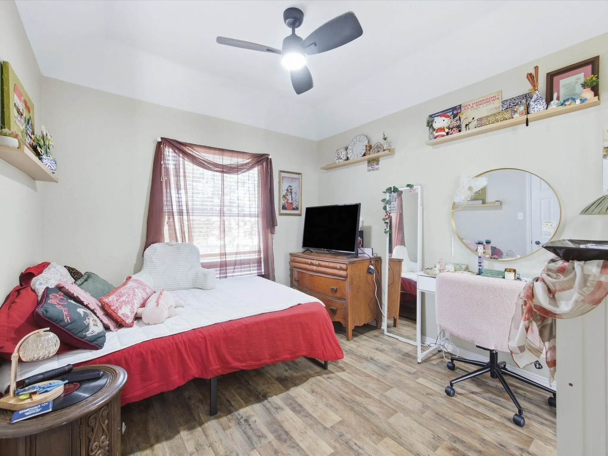 Wood-finish flooring, ceiling fan, and wall-mounted shelving