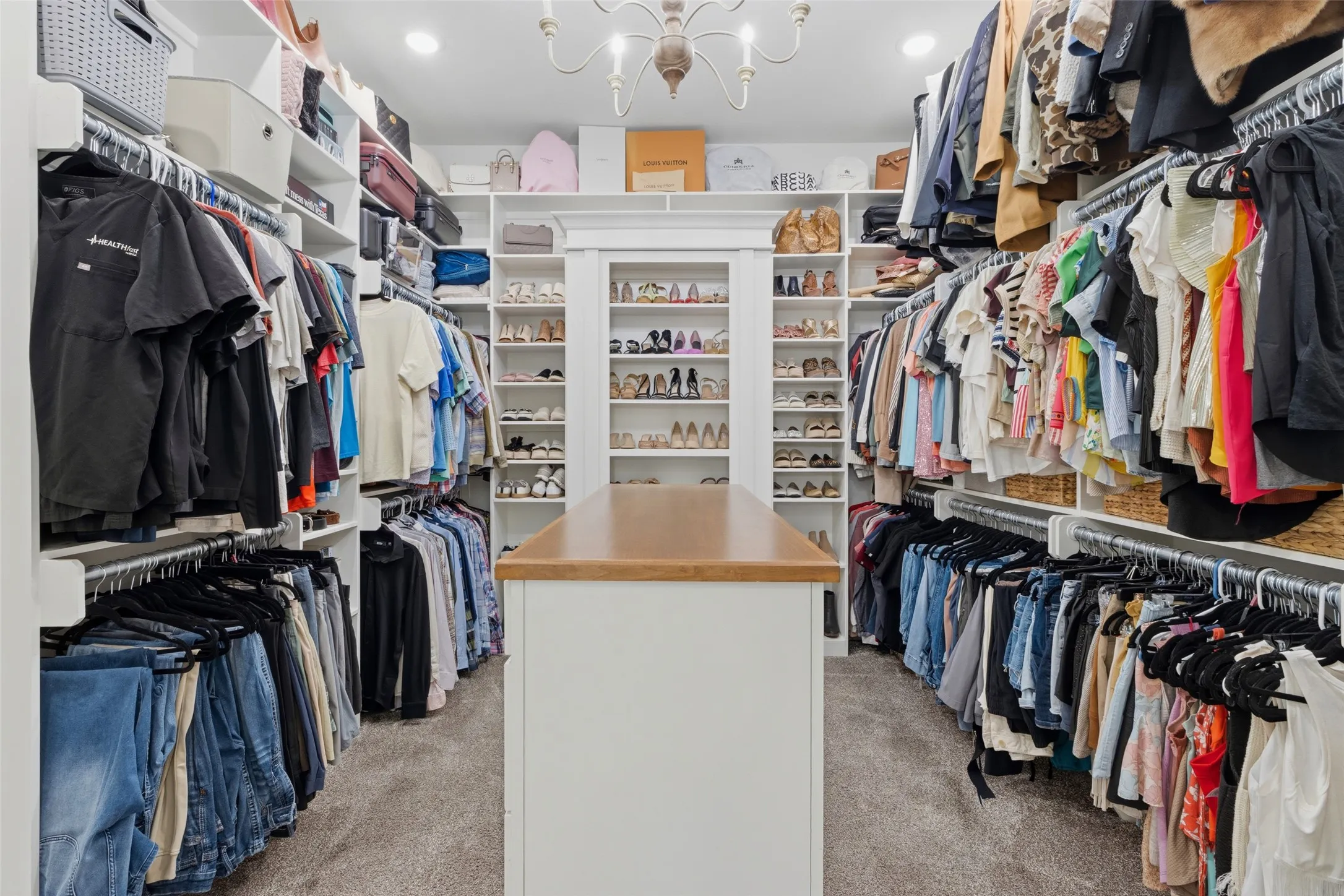 primary closet with hidden safe room behind shoe wall