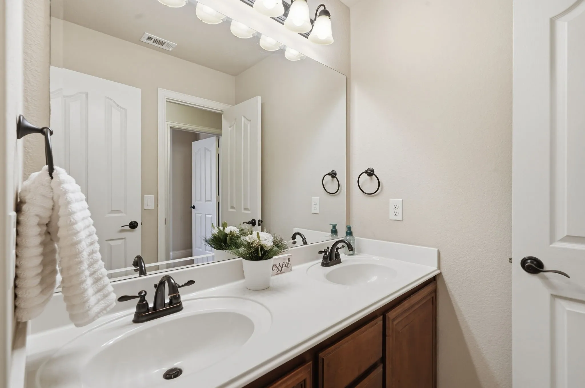 Double vanity with dark wood cabinetry & abundant storage