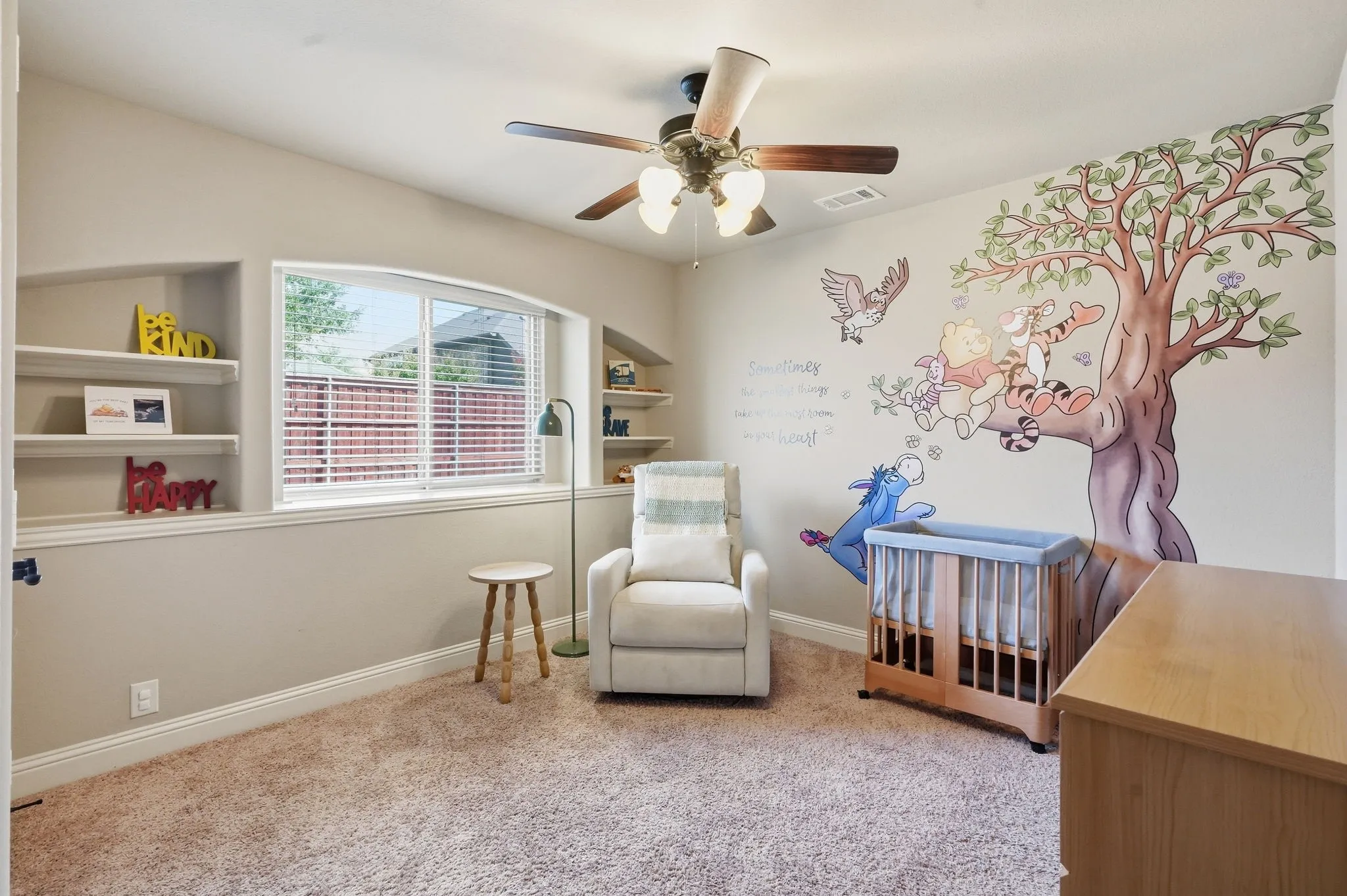 Main level bedroom featuring built-in shelving & large closet
