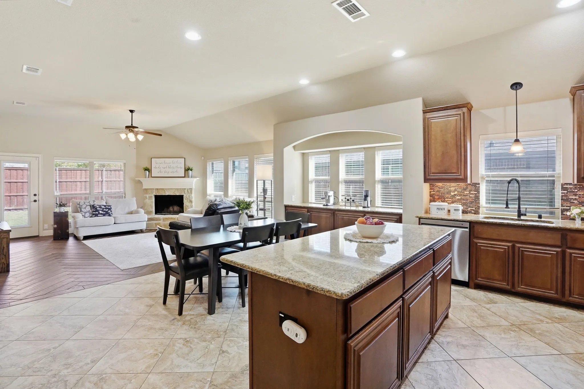 Open concept design with oversized island, granite countertops, and stainless steel appliances