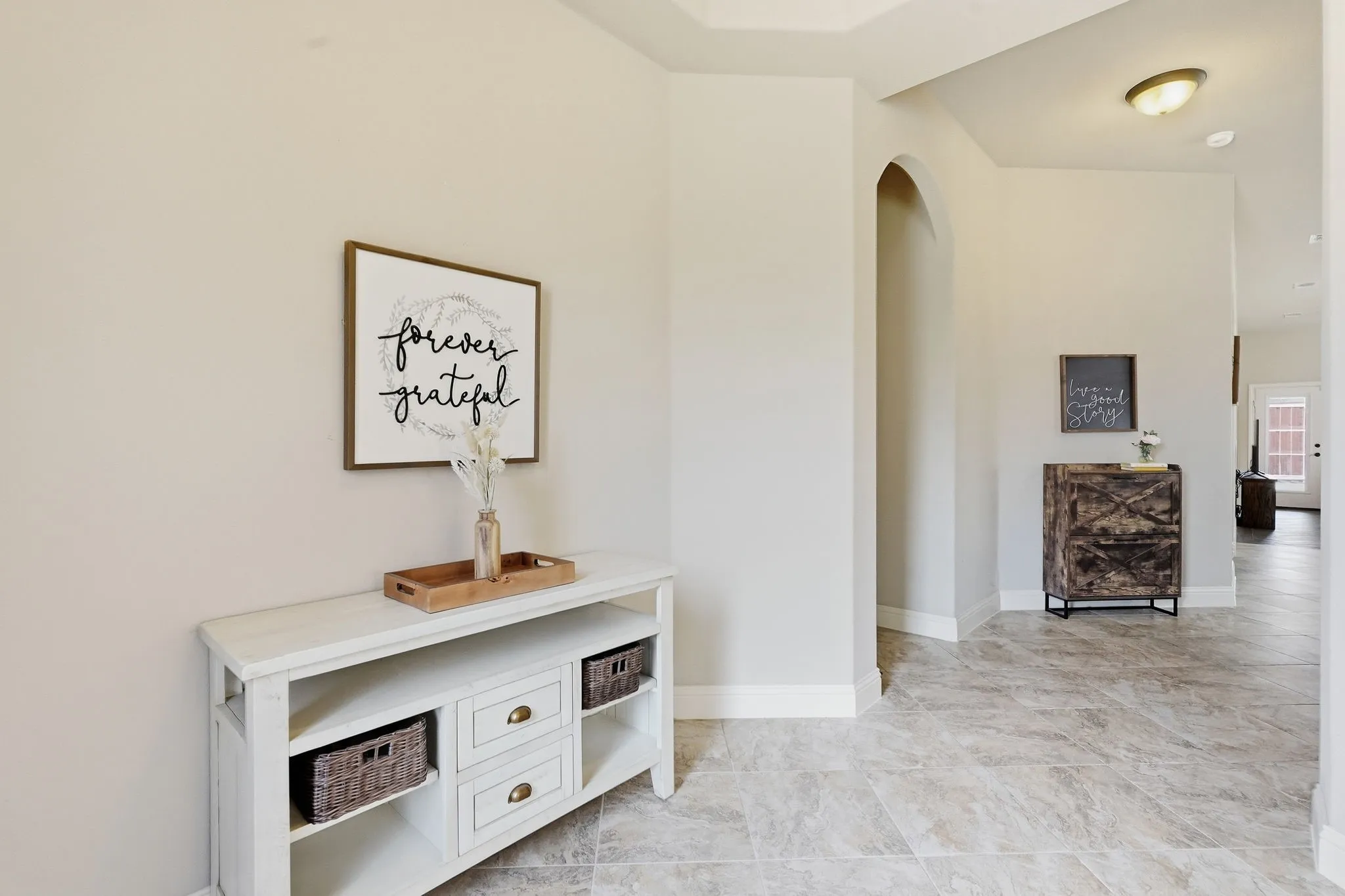 Spacious entry showing access to open-concept living area