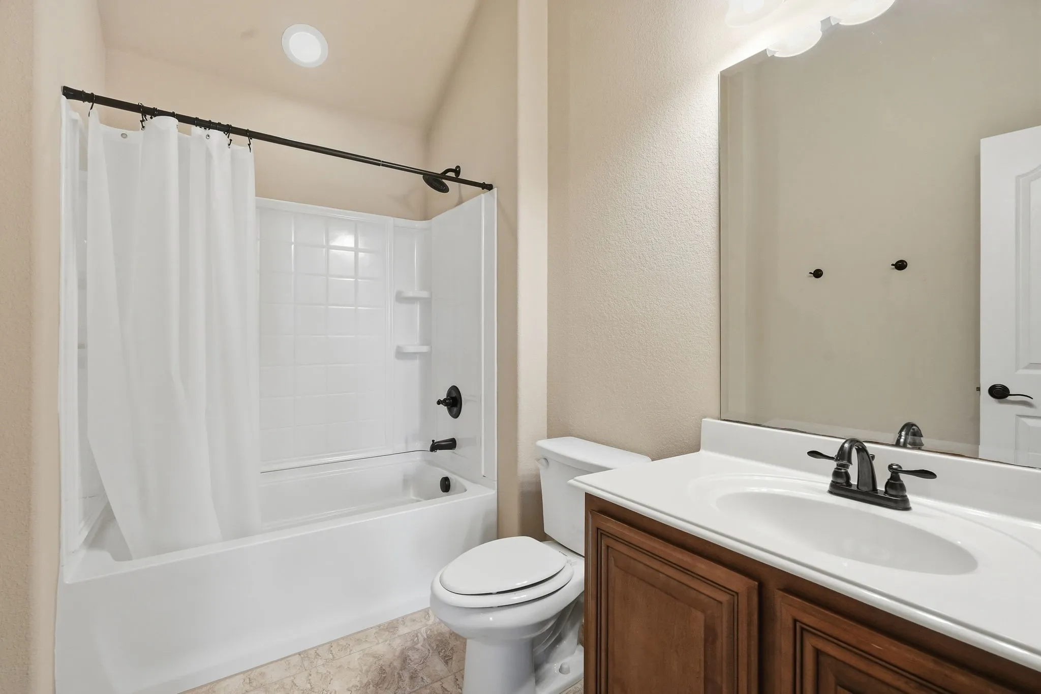Full bathroom on 2nd level with a bathtub/ shower combination & single vanity with black fixtures