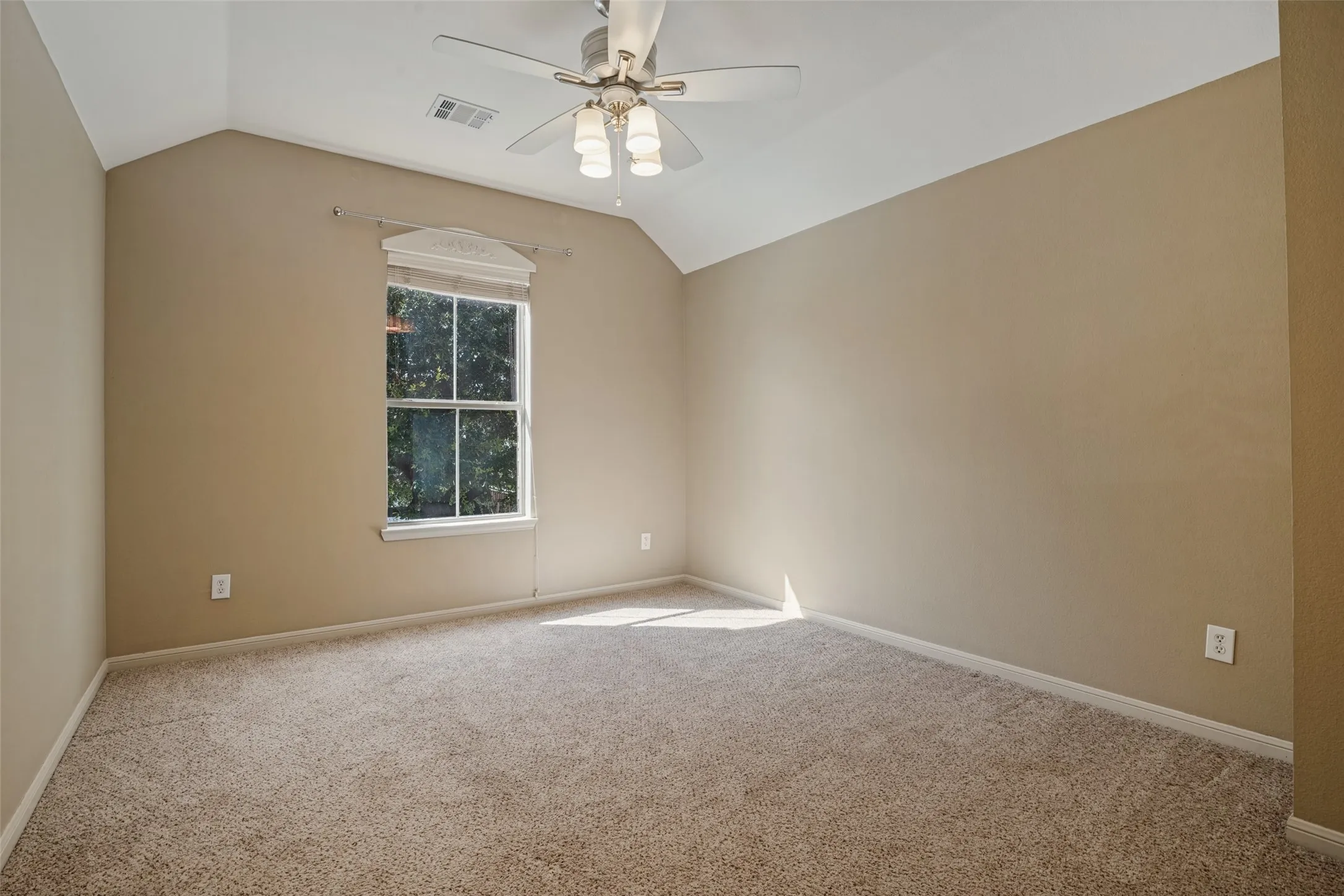 Bedroom #2 has Vaulted ceiling, ceiling fan, neutral carpet flooring, single window with trim, and neutral wall tones and walk in closet