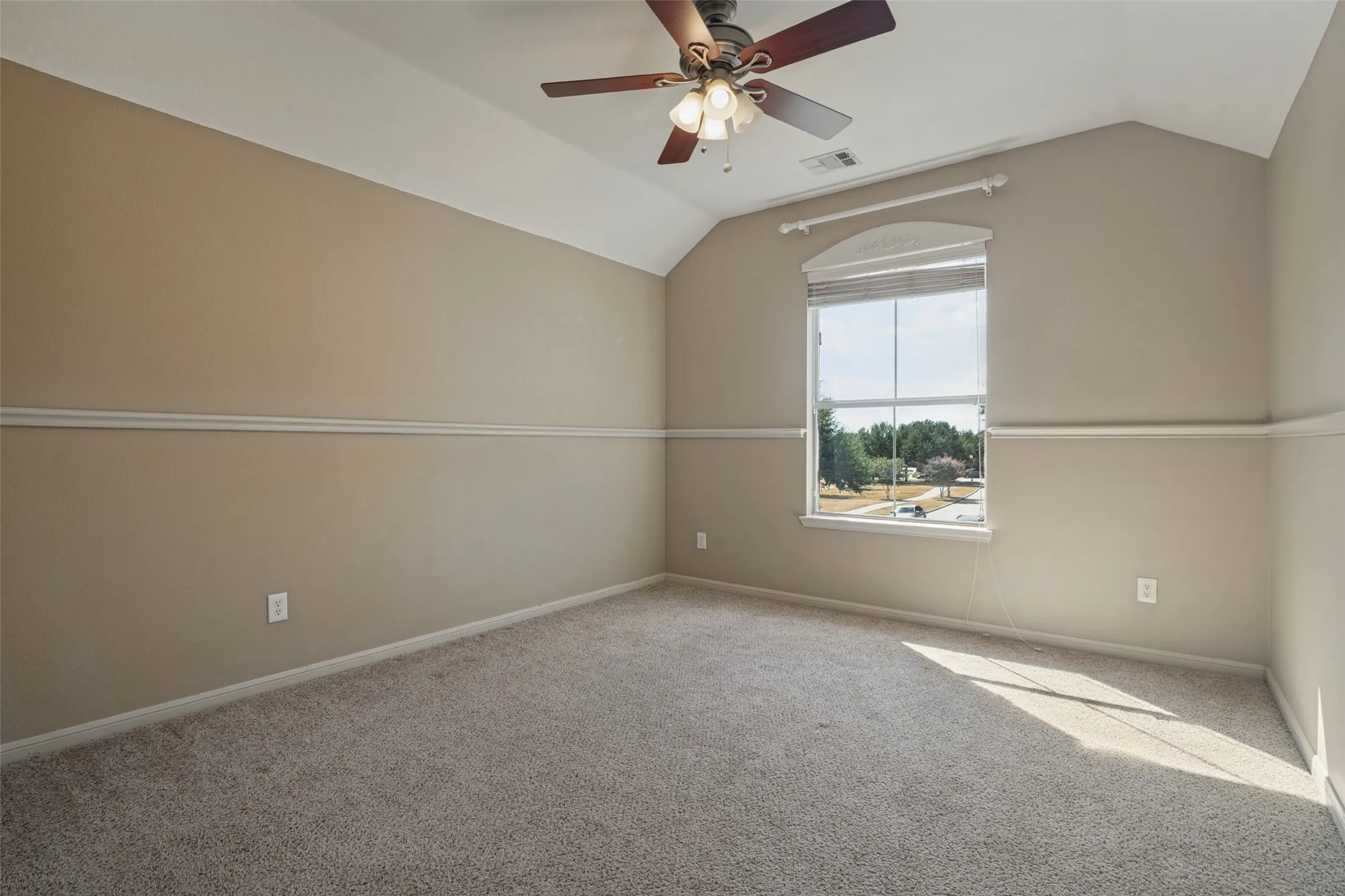 Bedroom #4 has Vaulted ceiling with a ceiling fan, carpet flooring, a window with blinds, and decorative chair rail molding and walk in closet