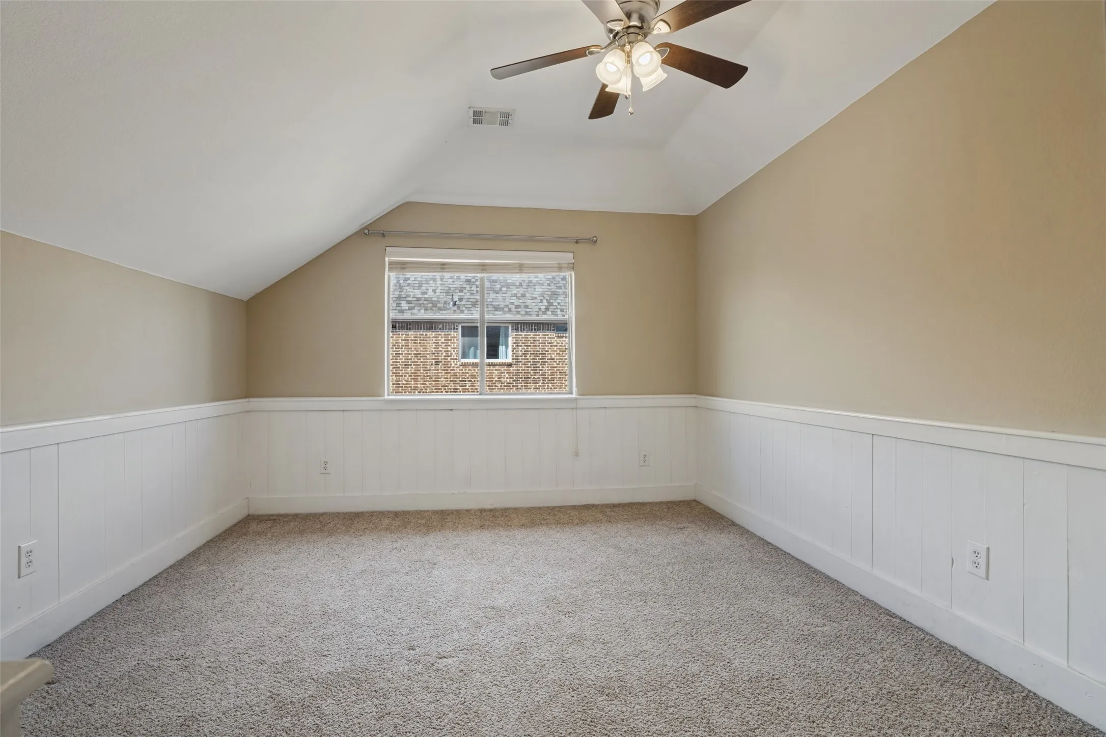 Bedroom #3 Vaulted ceiling with a ceiling fan, carpeted flooring, paneled wainscoting, and a window with blinds and walk in closet
