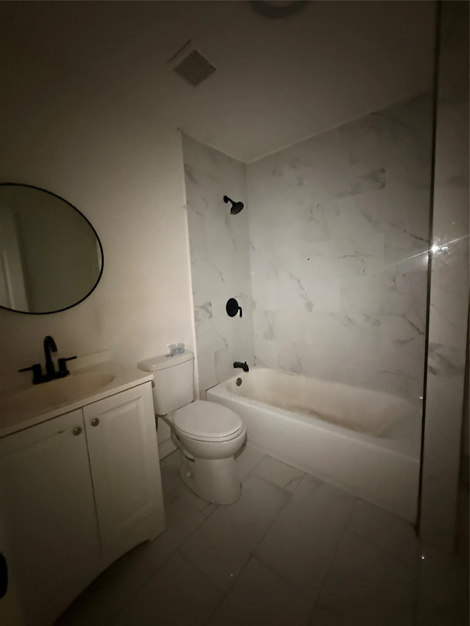 White vanity with integrated sink and black faucet