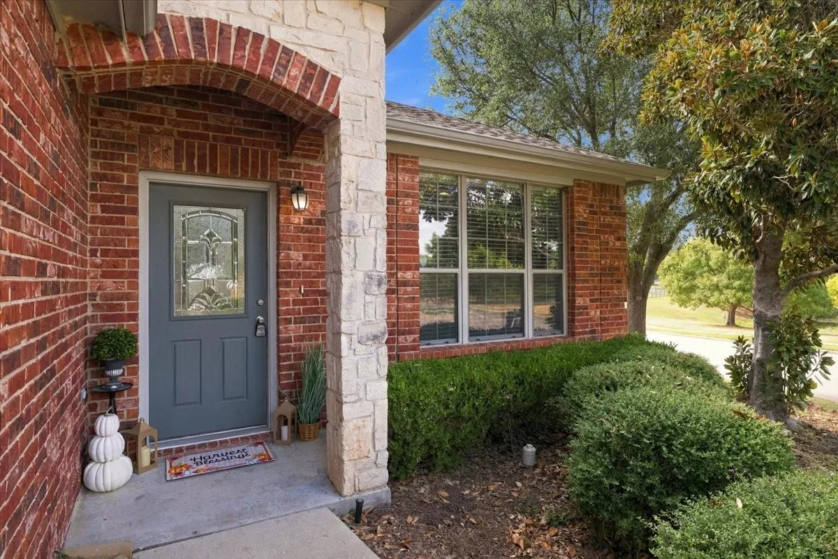 Brick and stone facade with an arched entry