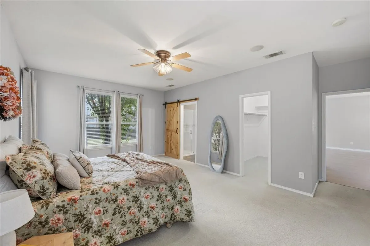 Recessed lighting, ceiling fan, carpeting, and multiple windows