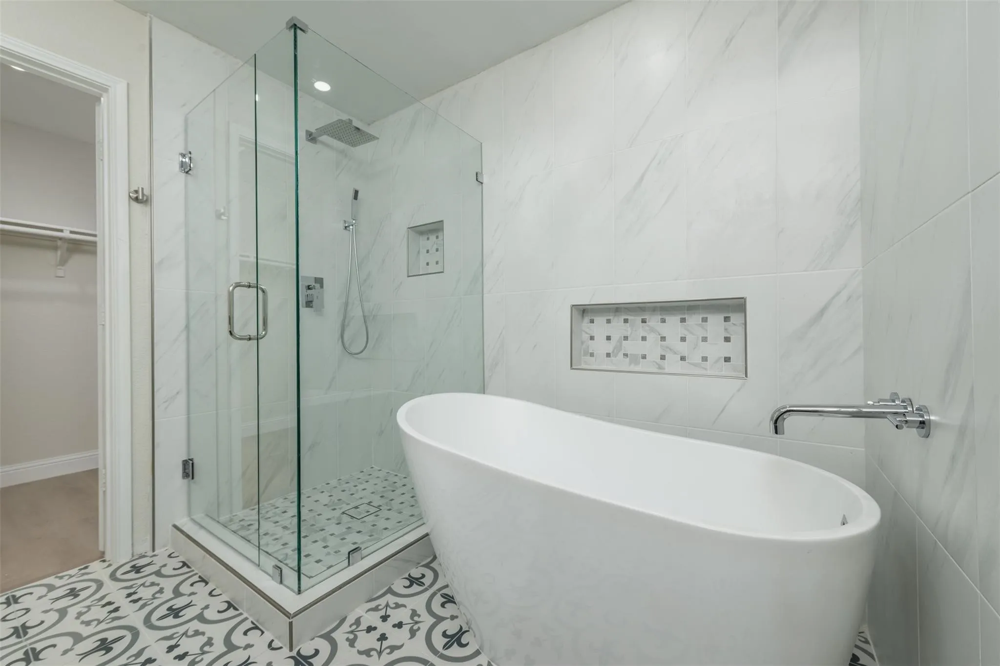 Bathroom featuring tile walls, tile patterned floors, and separate shower and tub