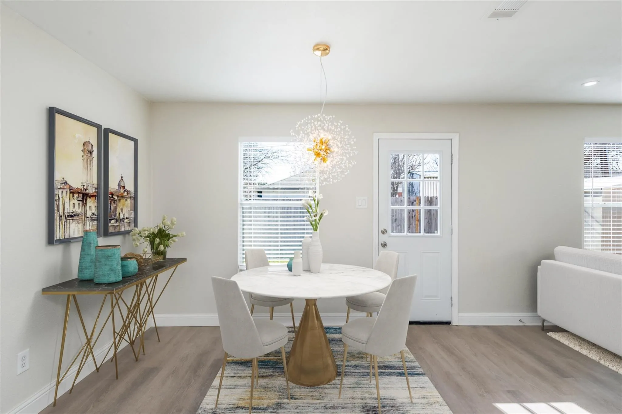 Dining room featuring light hardwood / wood-style flooring, plenty of natural light, and an inviting chandelier