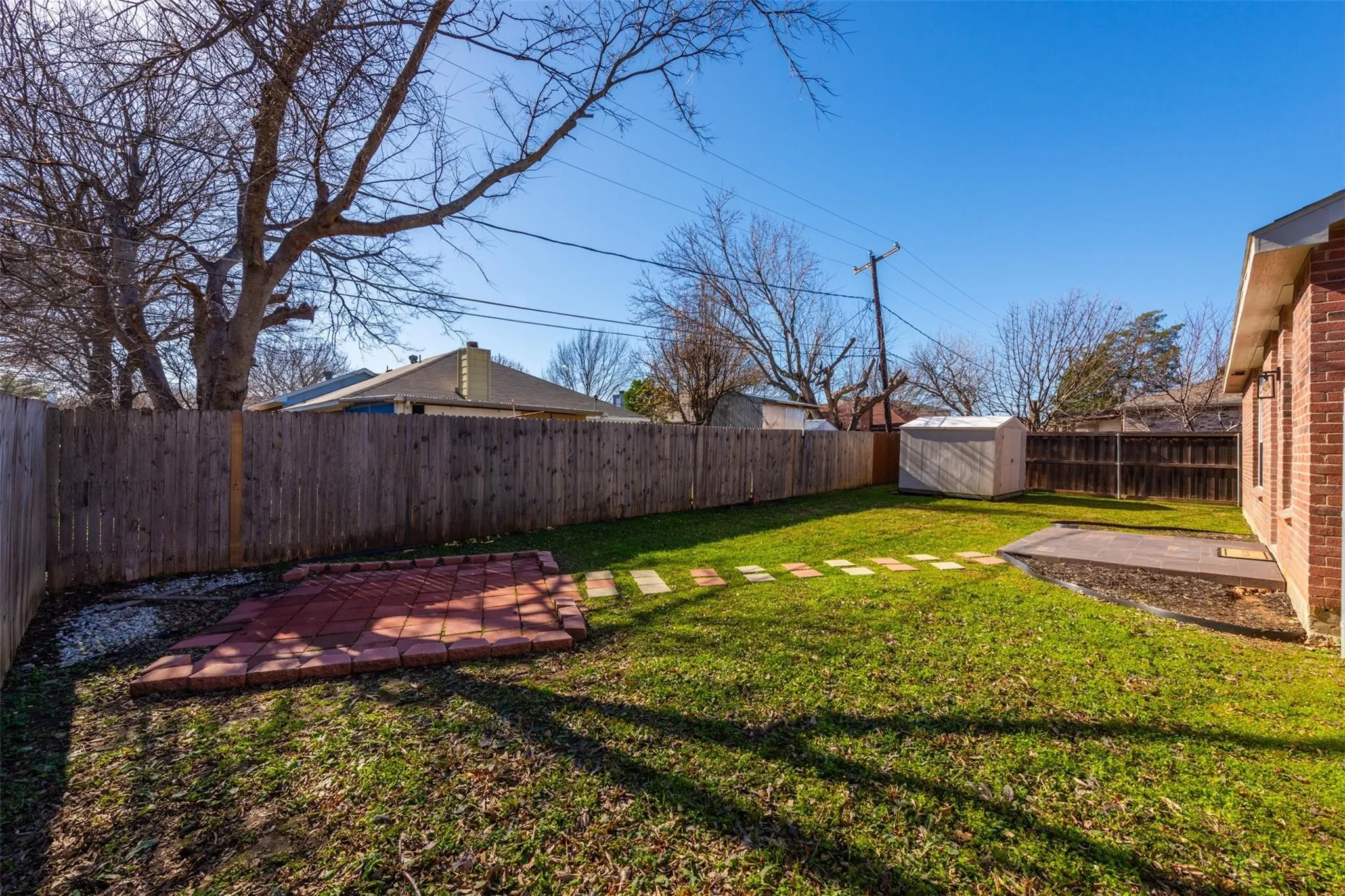 View of yard with a shed and a patio