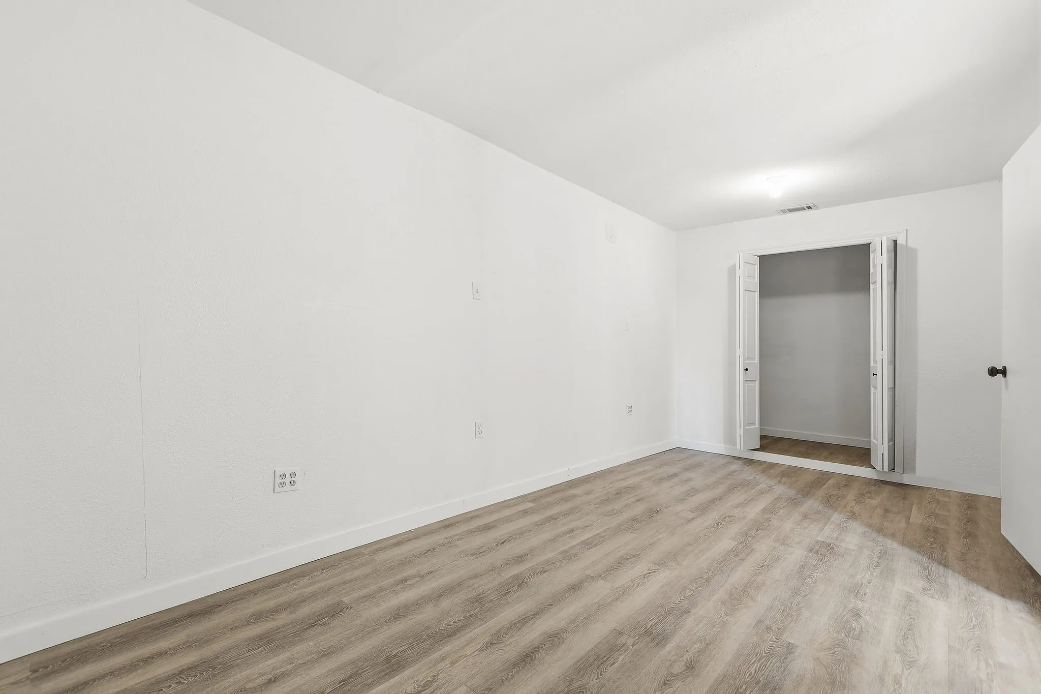 Extra bonus room - Spacious room featuring wood-finish flooring and a closet with bi-fold doors