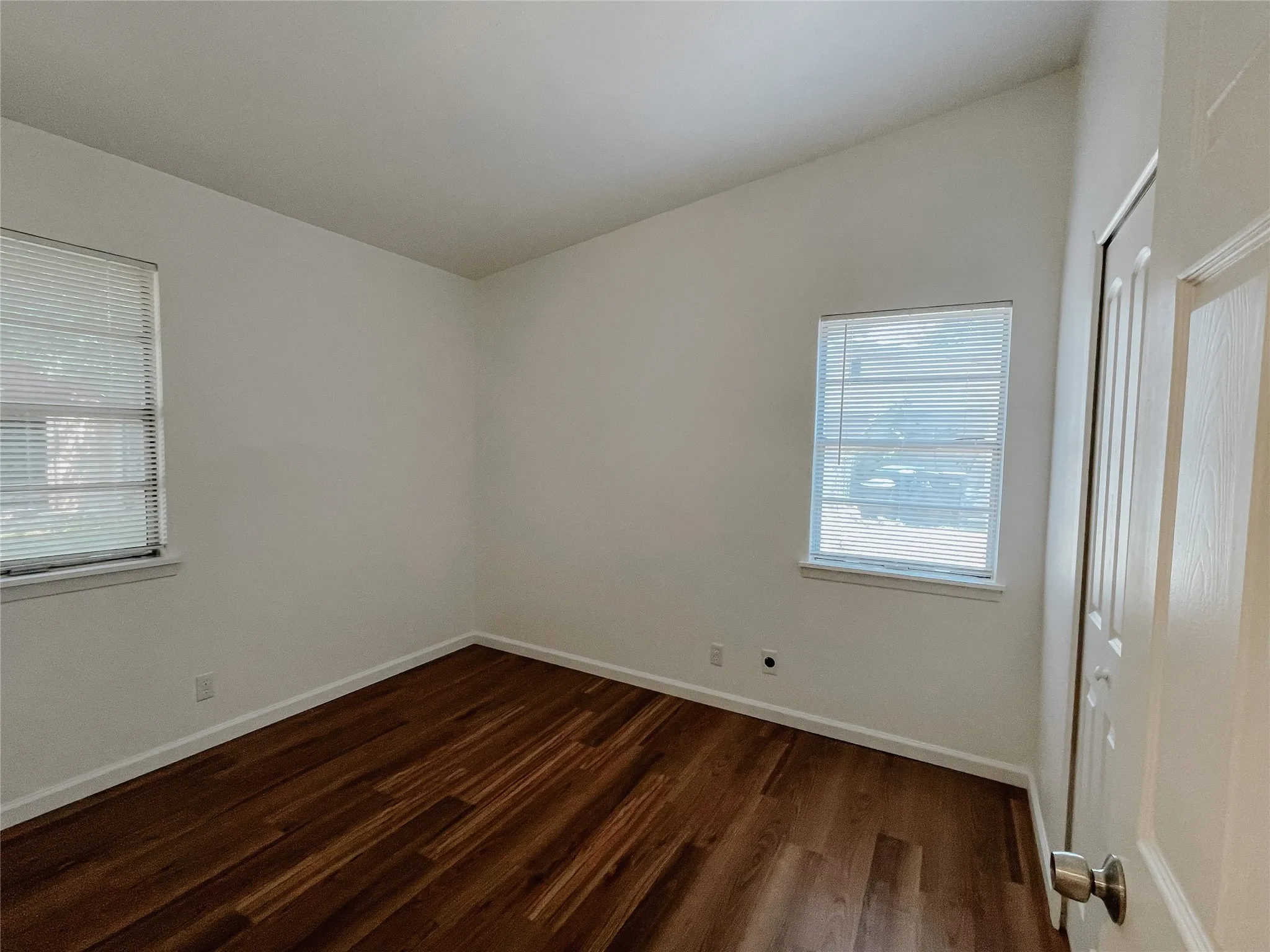 Spare room featuring dark hardwood / wood-style flooring
