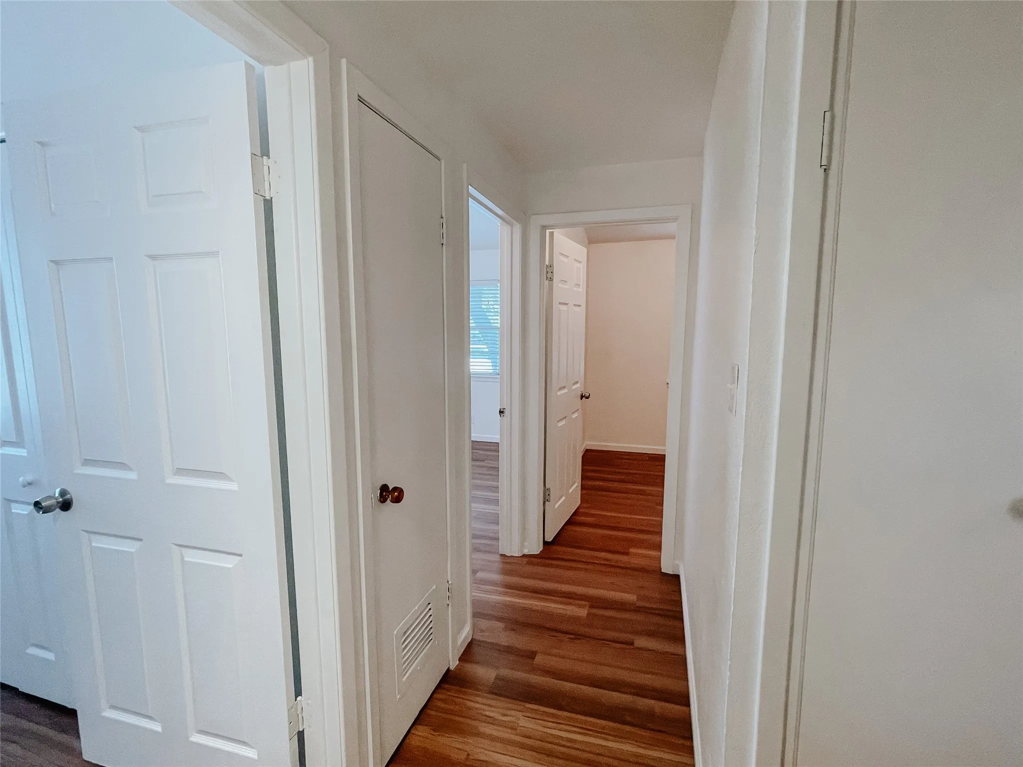 Corridor featuring dark wood-type flooring