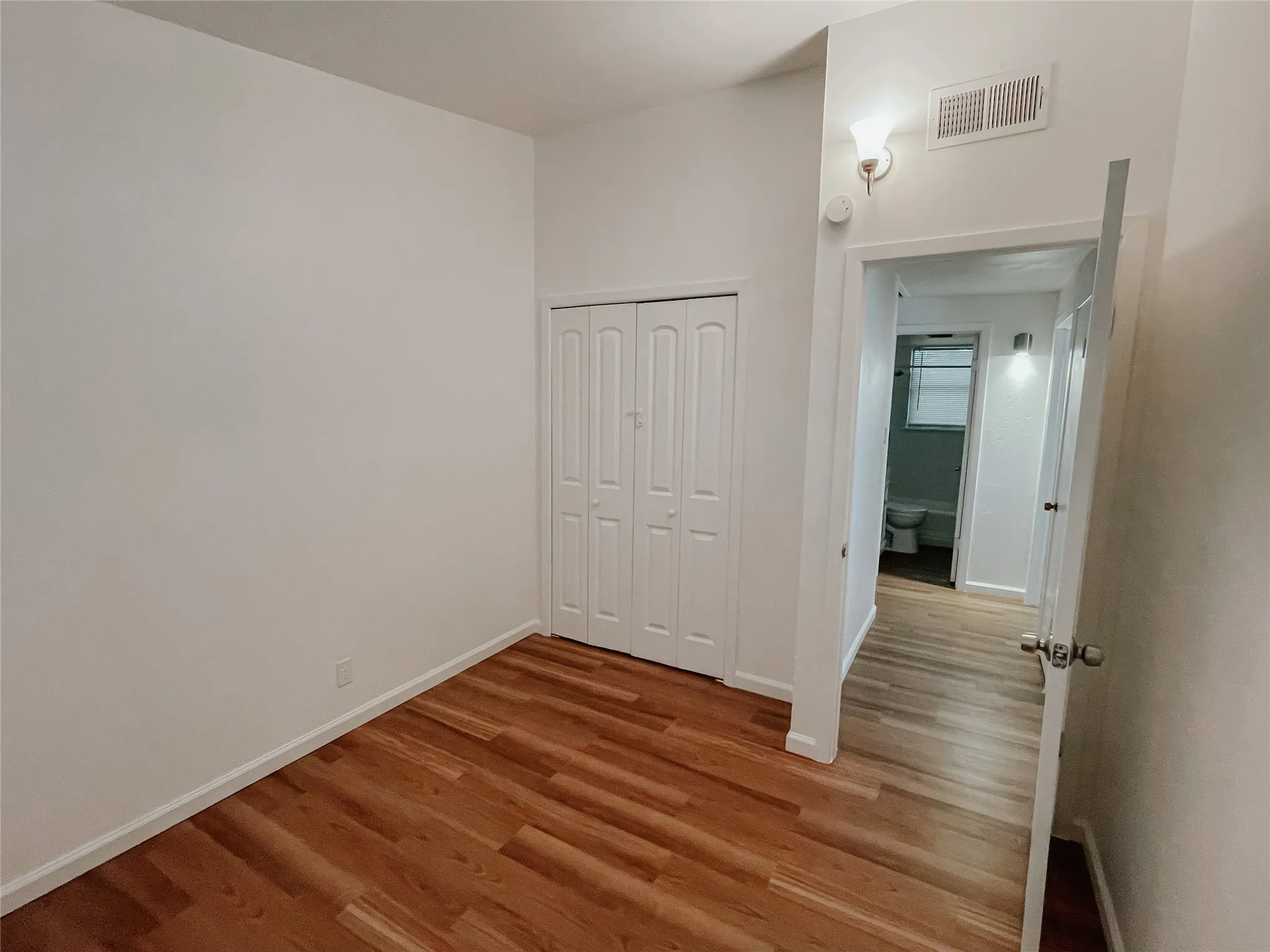 Unfurnished bedroom featuring light hardwood / wood-style floors and a closet