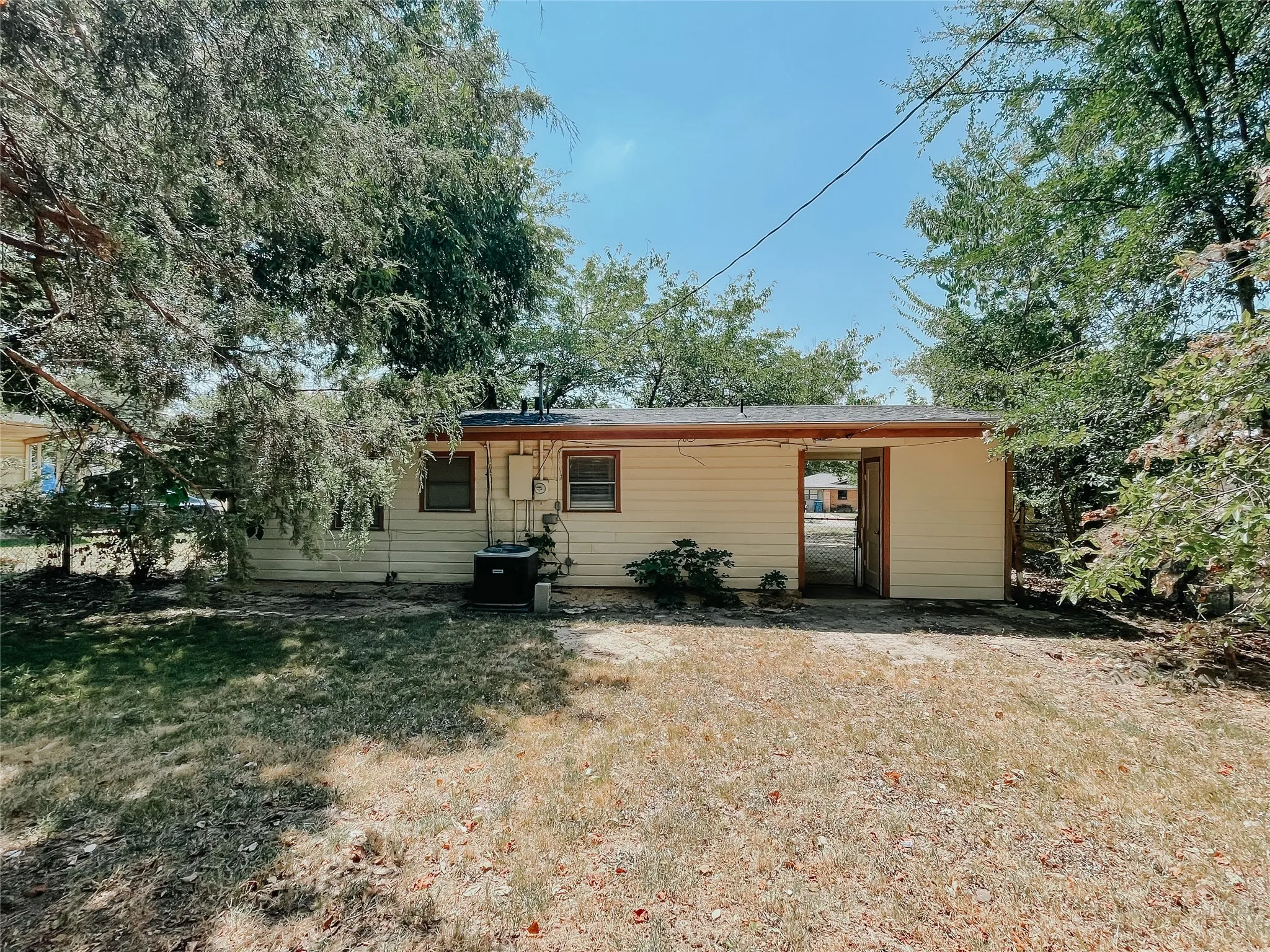 View of front of property with a front lawn and a carport