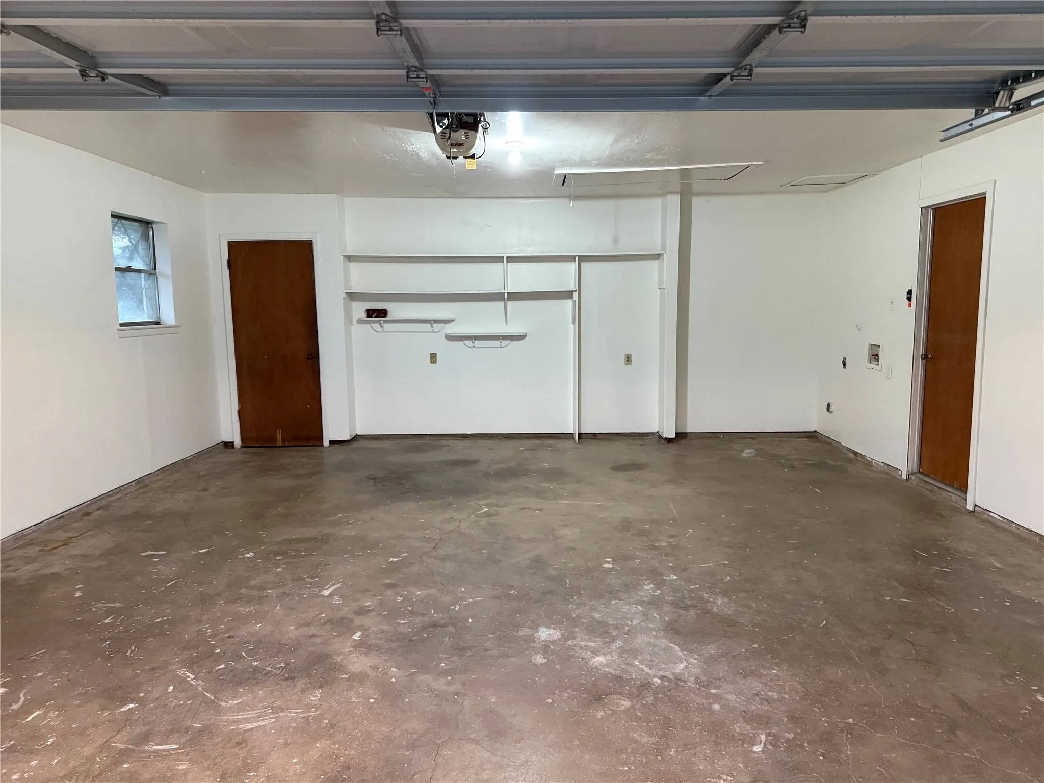 Garage featuring a garage door opener