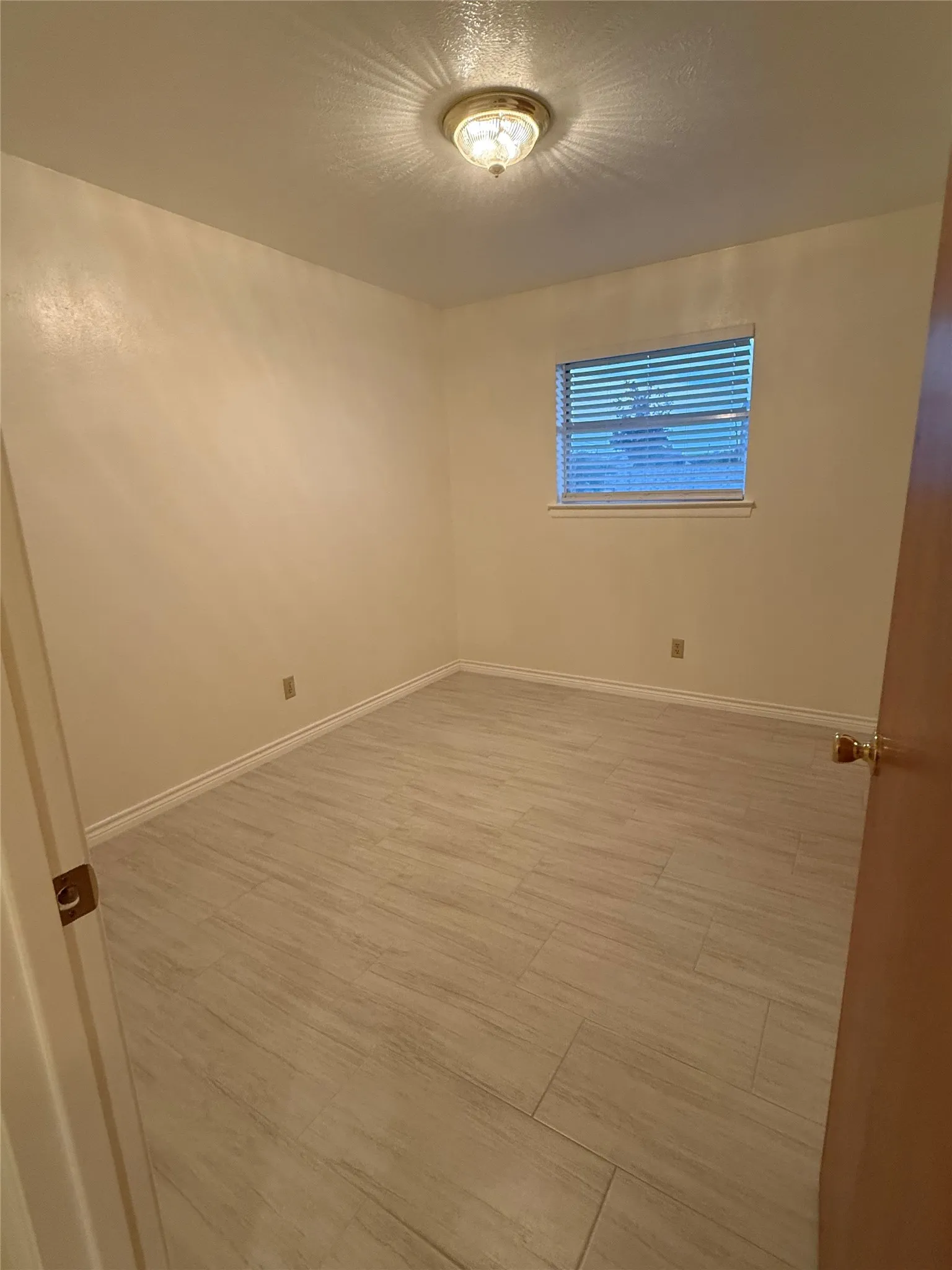 Unfurnished room with baseboards and light wood finished floors