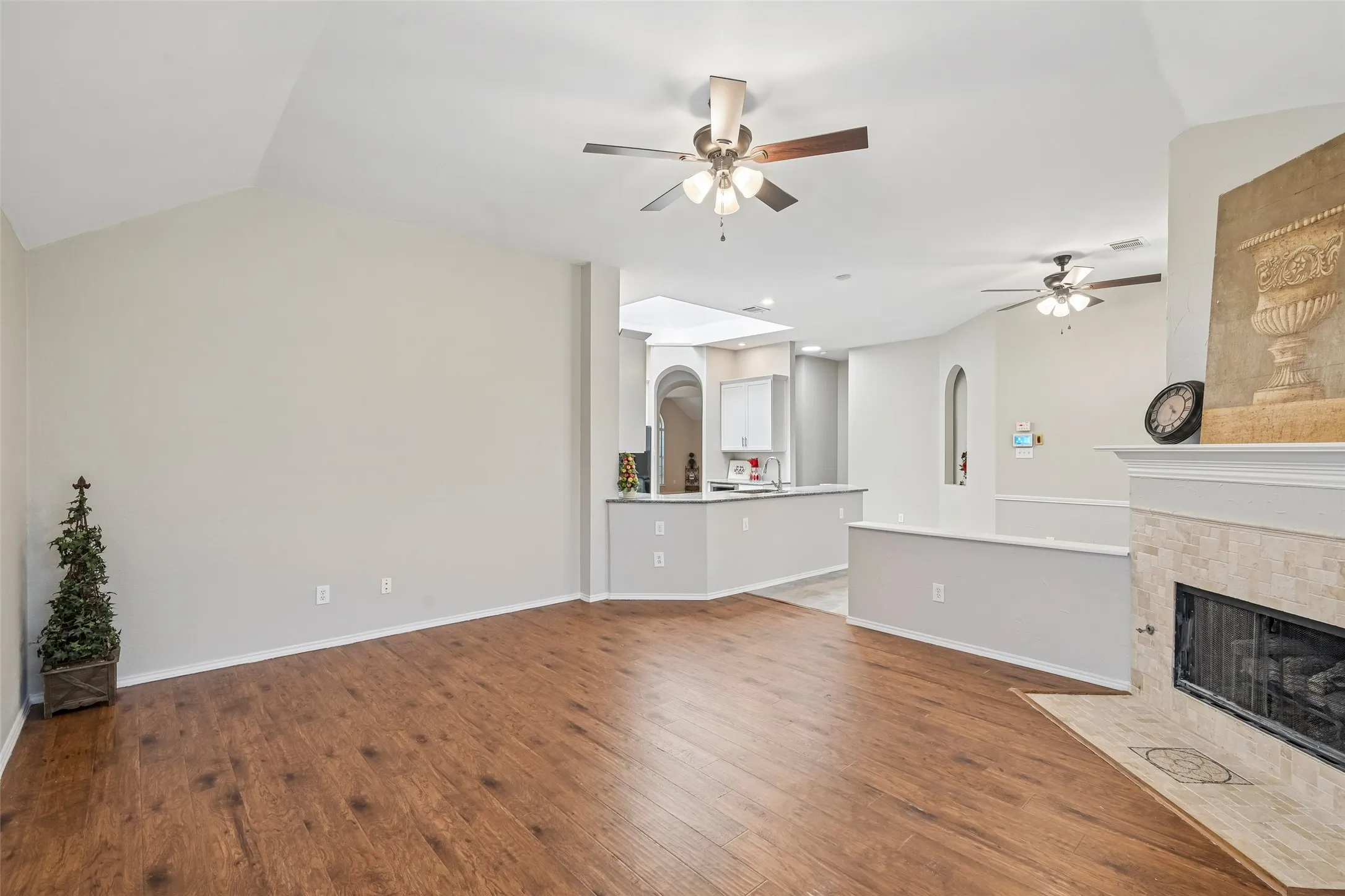 Wood-finish flooring, vaulted ceiling, and recessed lighting