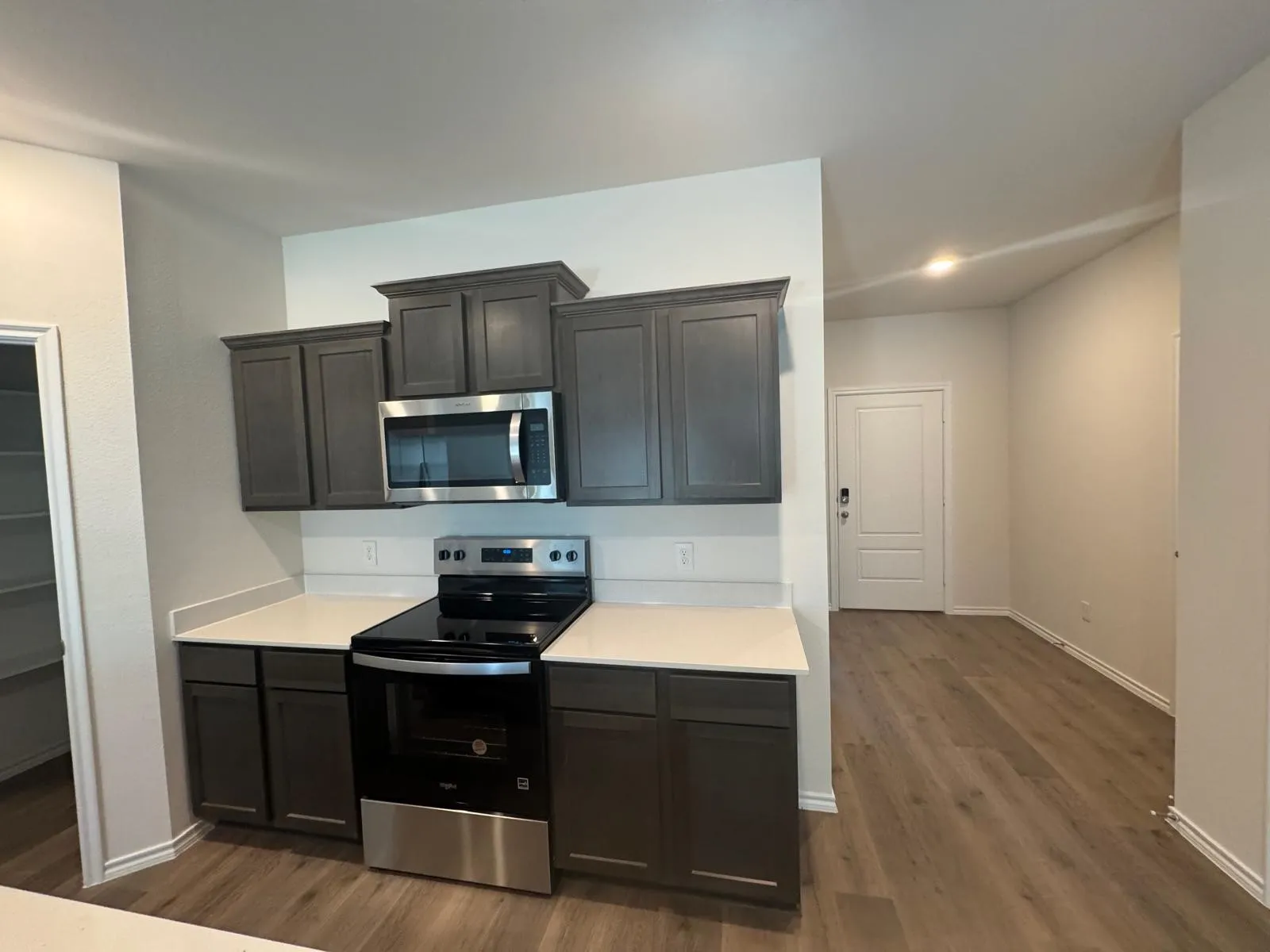 Kitchen with stainless steel appliances and dark wood finished floors