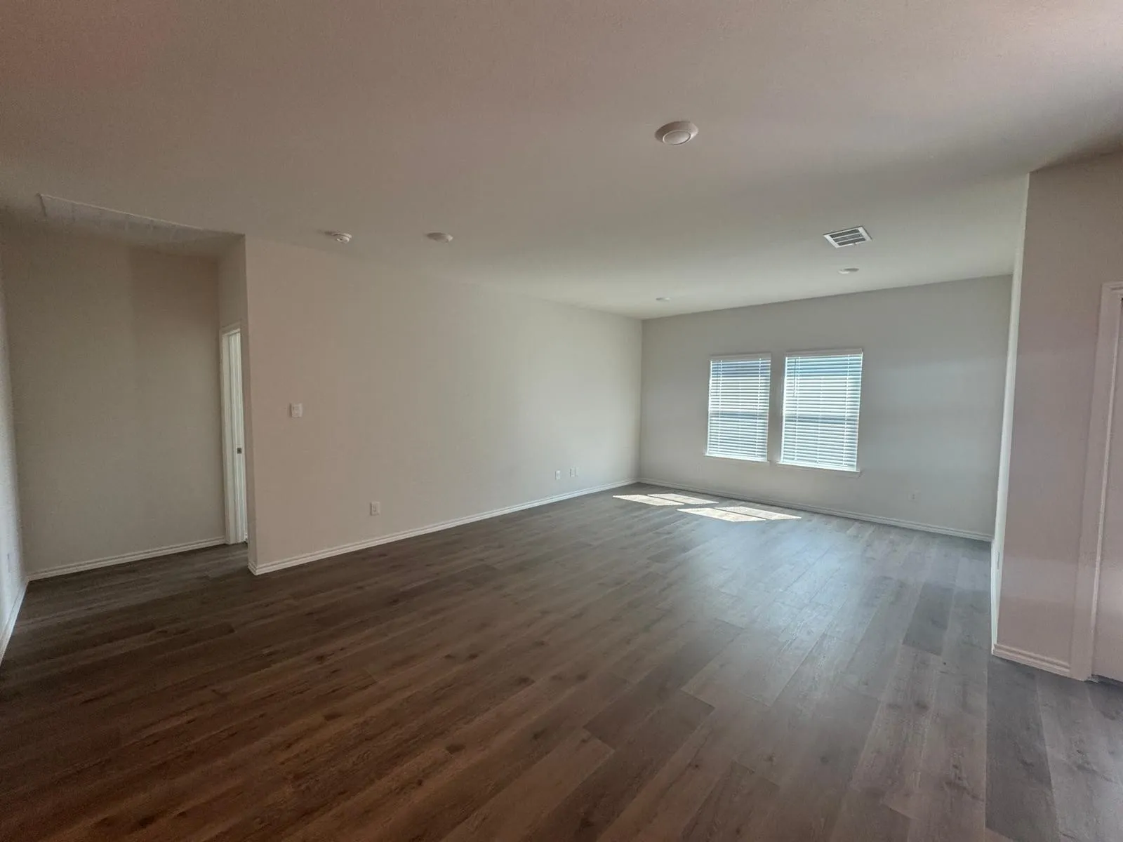 Unfurnished room with dark wood-type flooring