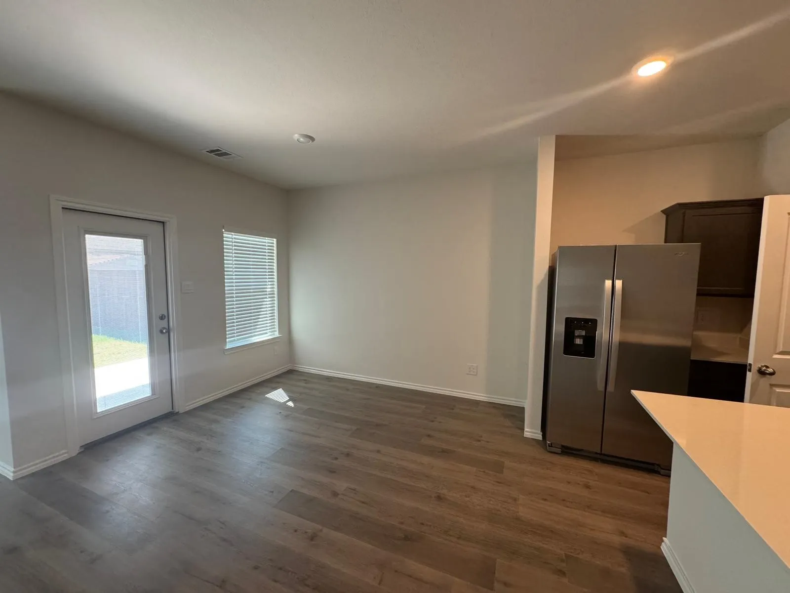 Unfurnished dining area with dark wood finished floors and recessed lighting