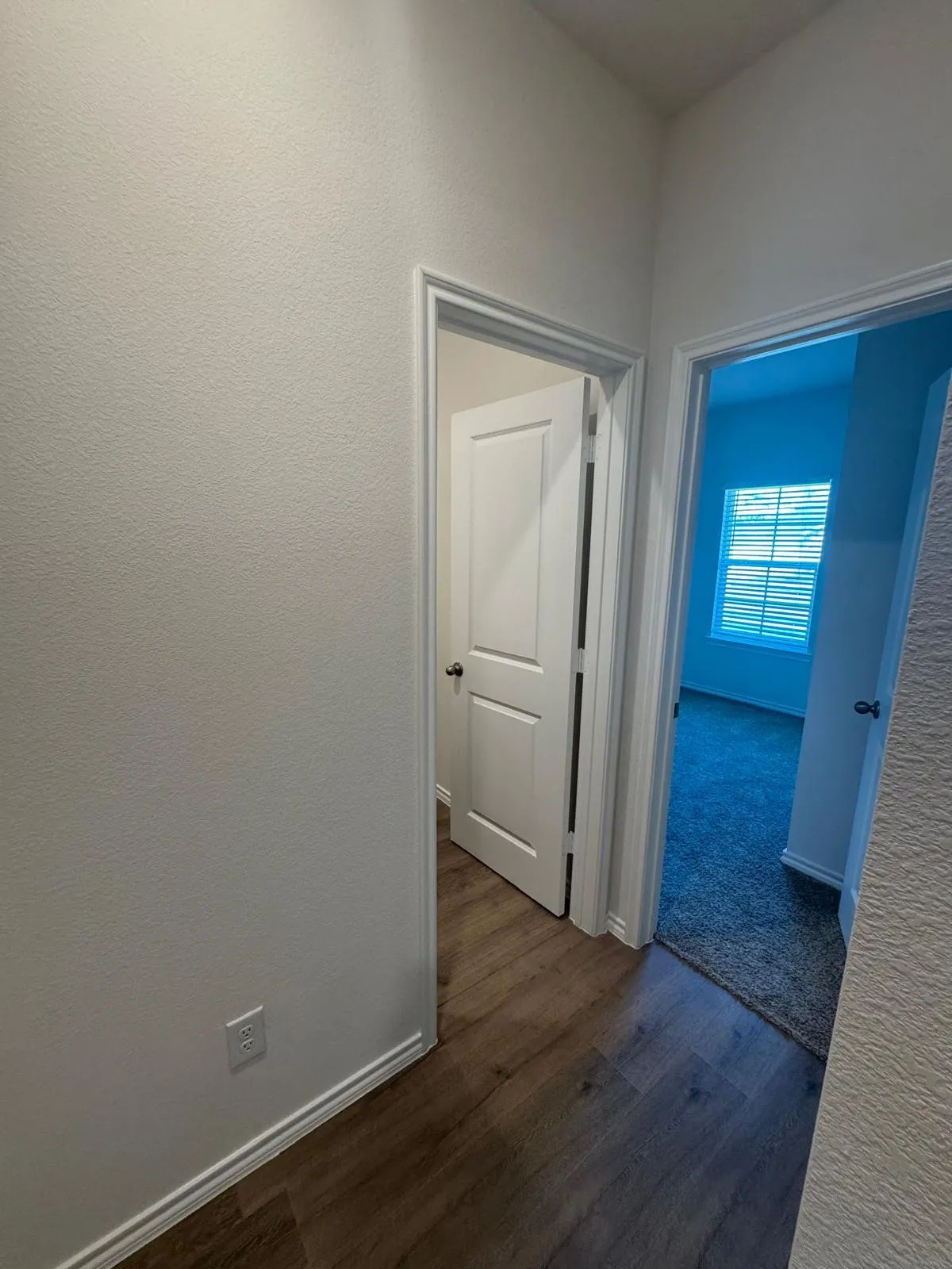 Corridor featuring dark wood finished floors