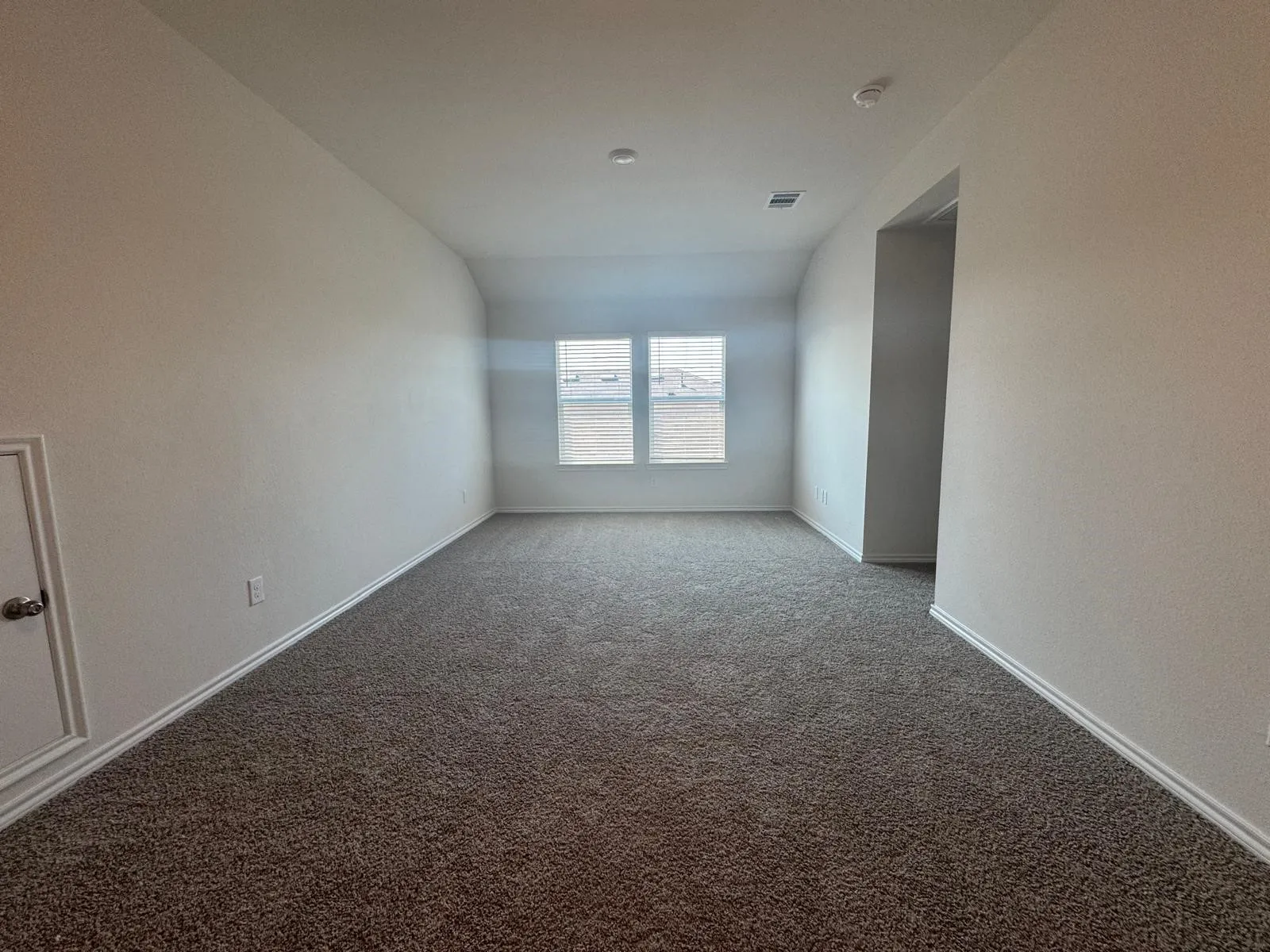 Carpeted spare room with baseboards