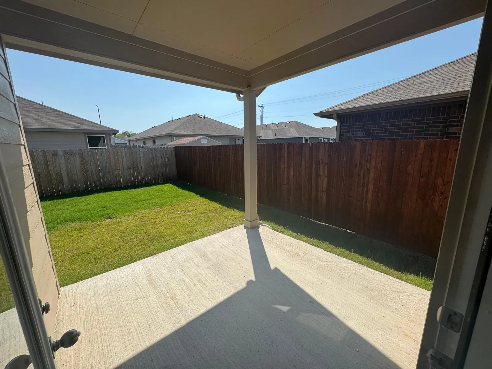 Fenced backyard featuring a patio