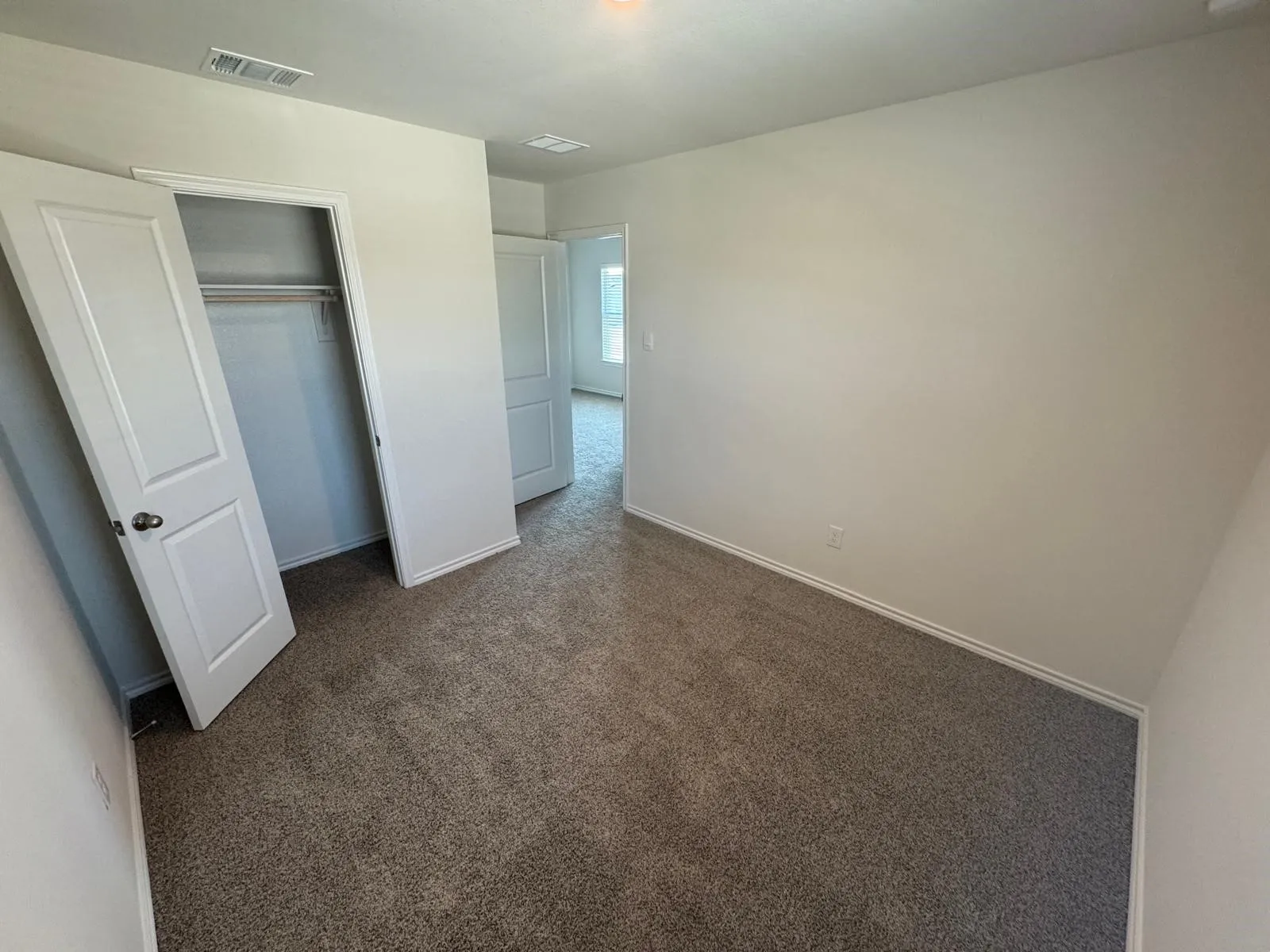 Unfurnished bedroom with carpet and a closet